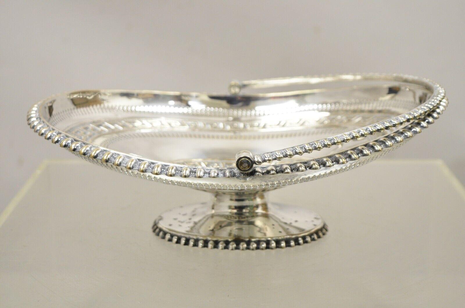 Antique English Regency Silver Plated Greek Key Cake Basket Serving Platter. Item features a serving handle, Greek key design, pedestal base, beaded trim, very nice antique item, great style and form. Circa 19th Century. Measurements: 4