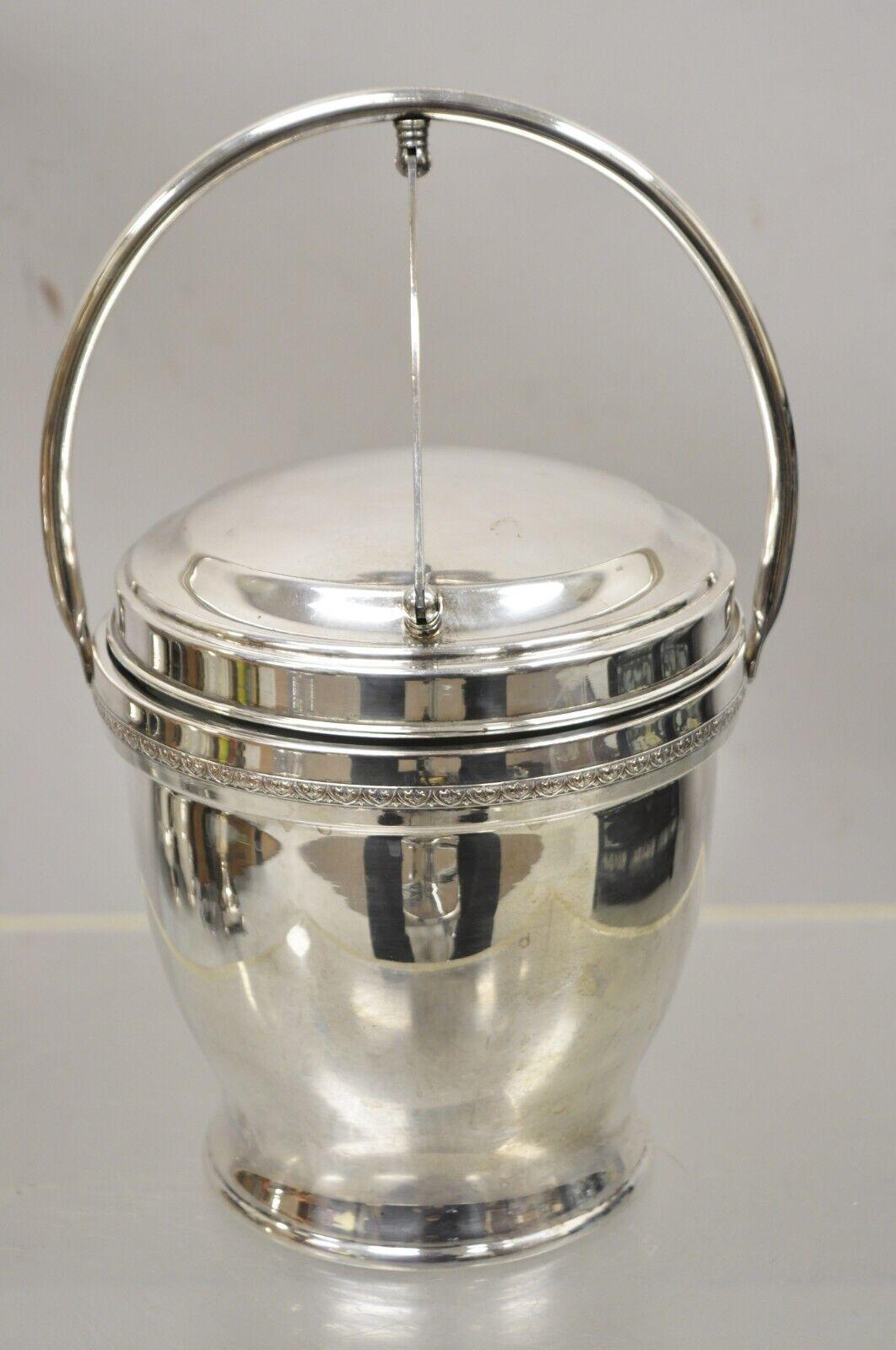 Antique English Regency Silver Plated Ice Bucket with Reticulating Hinge Lid Handle. Item features lion and shield crest to underside, mercury glass lined interior, lifting lid with reticulating swing handle, very nice vintage item, quality