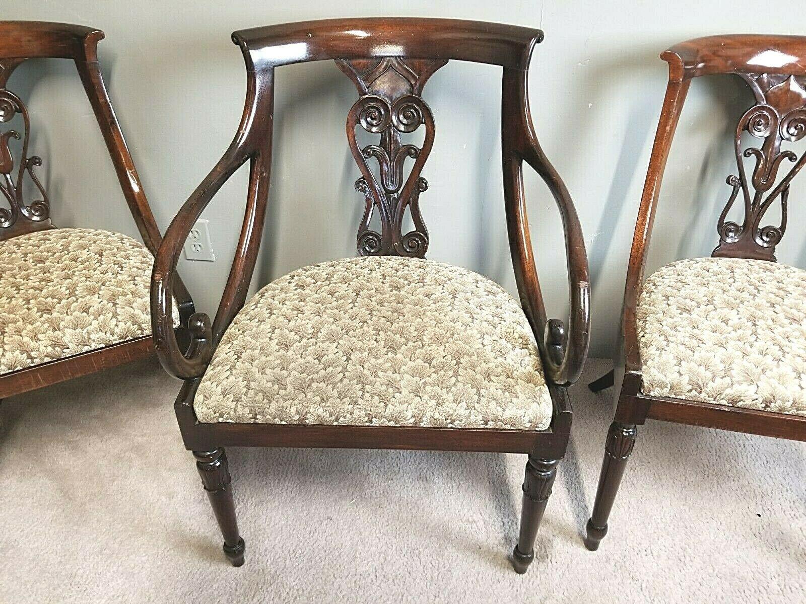 Offering one of our recent Palm Beach Estate fine furniture acquisitions of a
set of 5 antique English regency solid mahogany scroll arm dining chairs.

1890s Antique Hollywood Regency-style dining chairs feature solid mahogany wood frames