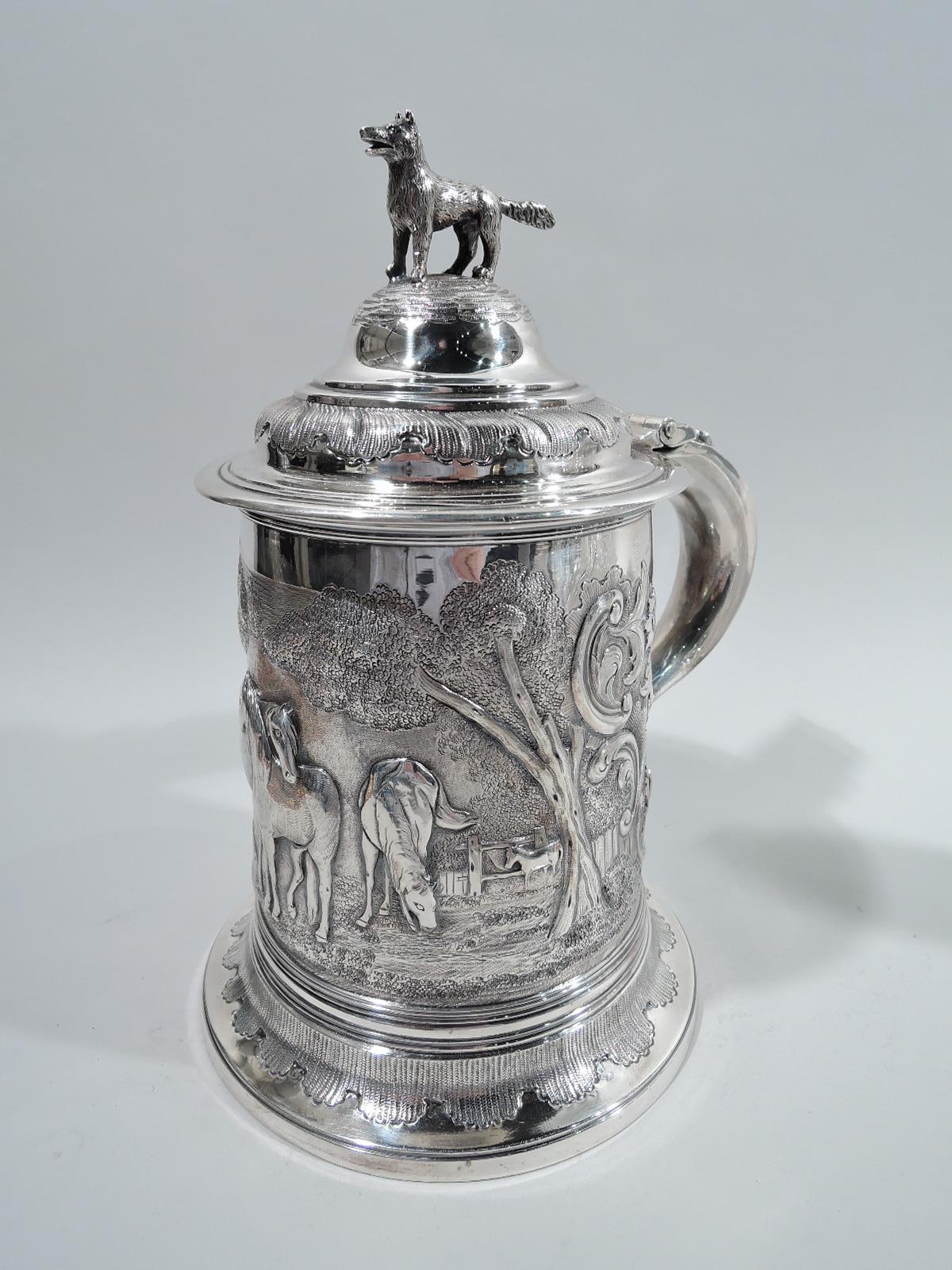 William IV sterling silver tankard. Made by William Chawner in London in 1834. Drum-form with spread foot, strap-hinged and double-domed cover, and s-scroll handle. Chased, engraved, and embossed frieze depicting horses grazing in bosky paddock.