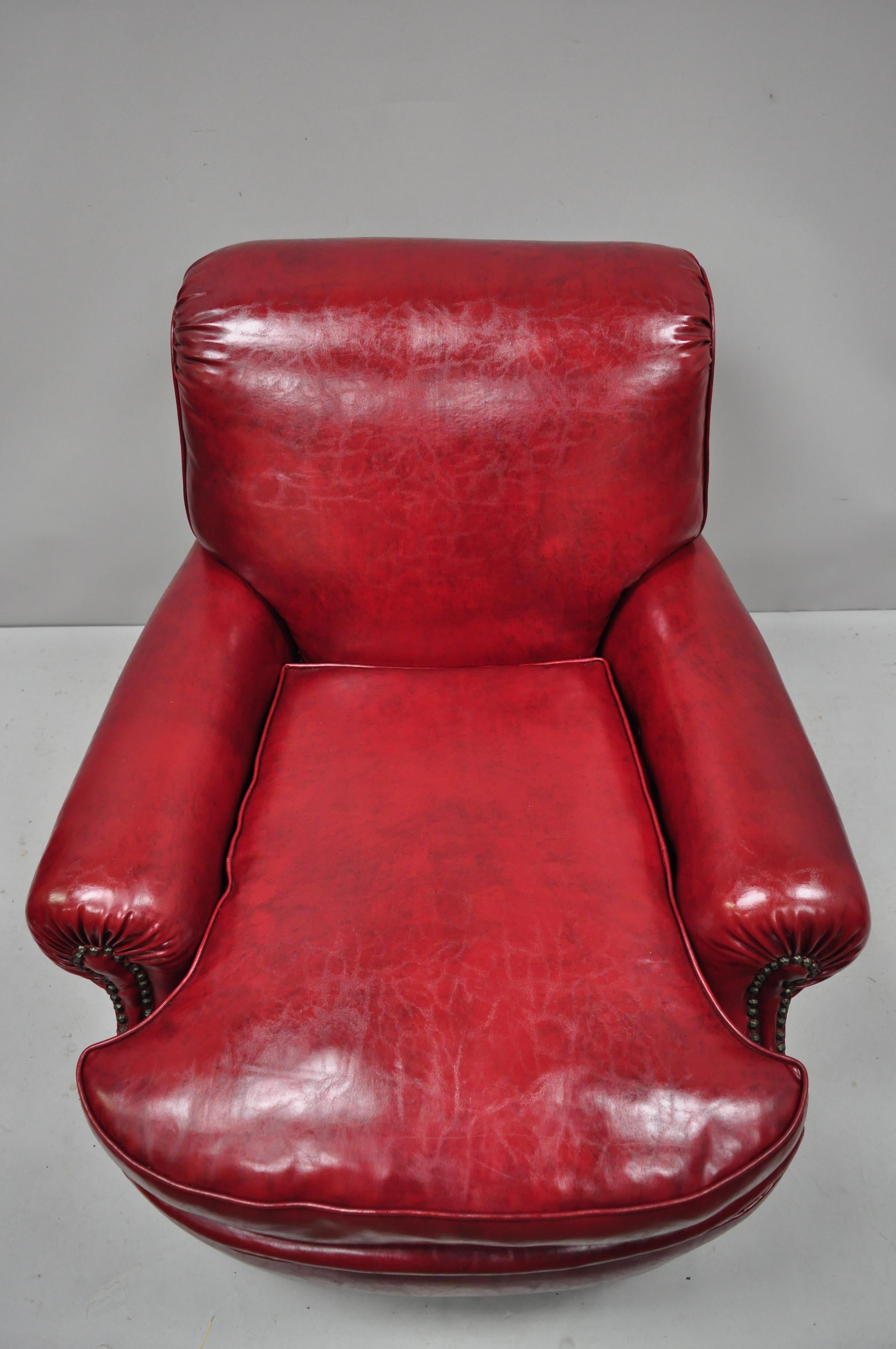 Antique English Regency style burgundy red vinyl faux leather club lounge chair. Item features rolling casters, deep comfortable cushion, nailhead trim, red/burgundy vinyl upholstery, rolled back and arms, solid wood frame, very nice vintage item,
