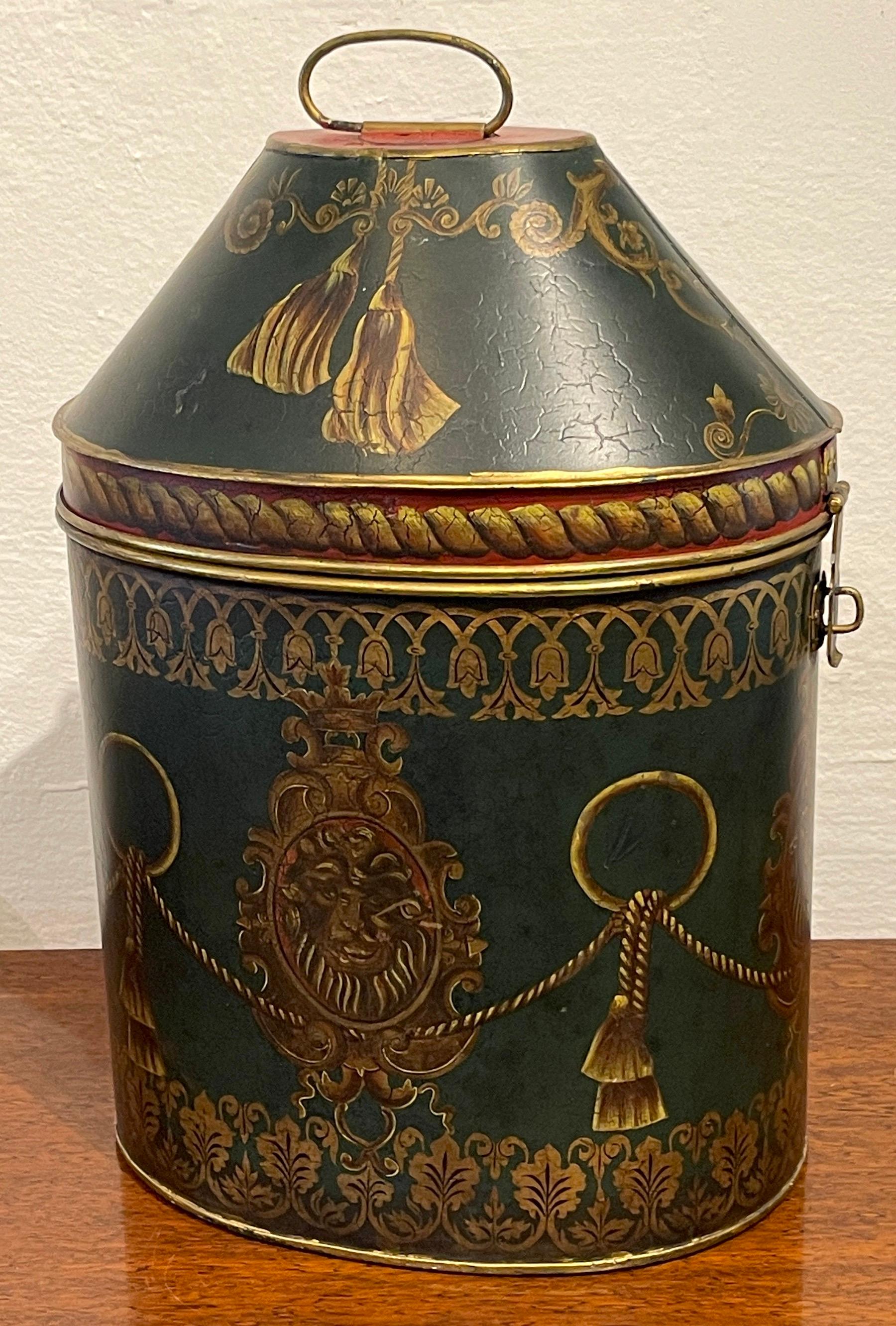 Antique English Regency Style Lion Motif  Oval Tole Box 
England, circa 1900s

A beautiful colorful example, of oval from with swing handle, on a tapering box decorated with tassels, lion medallions and trellis work.  Fitted with a latch handle,