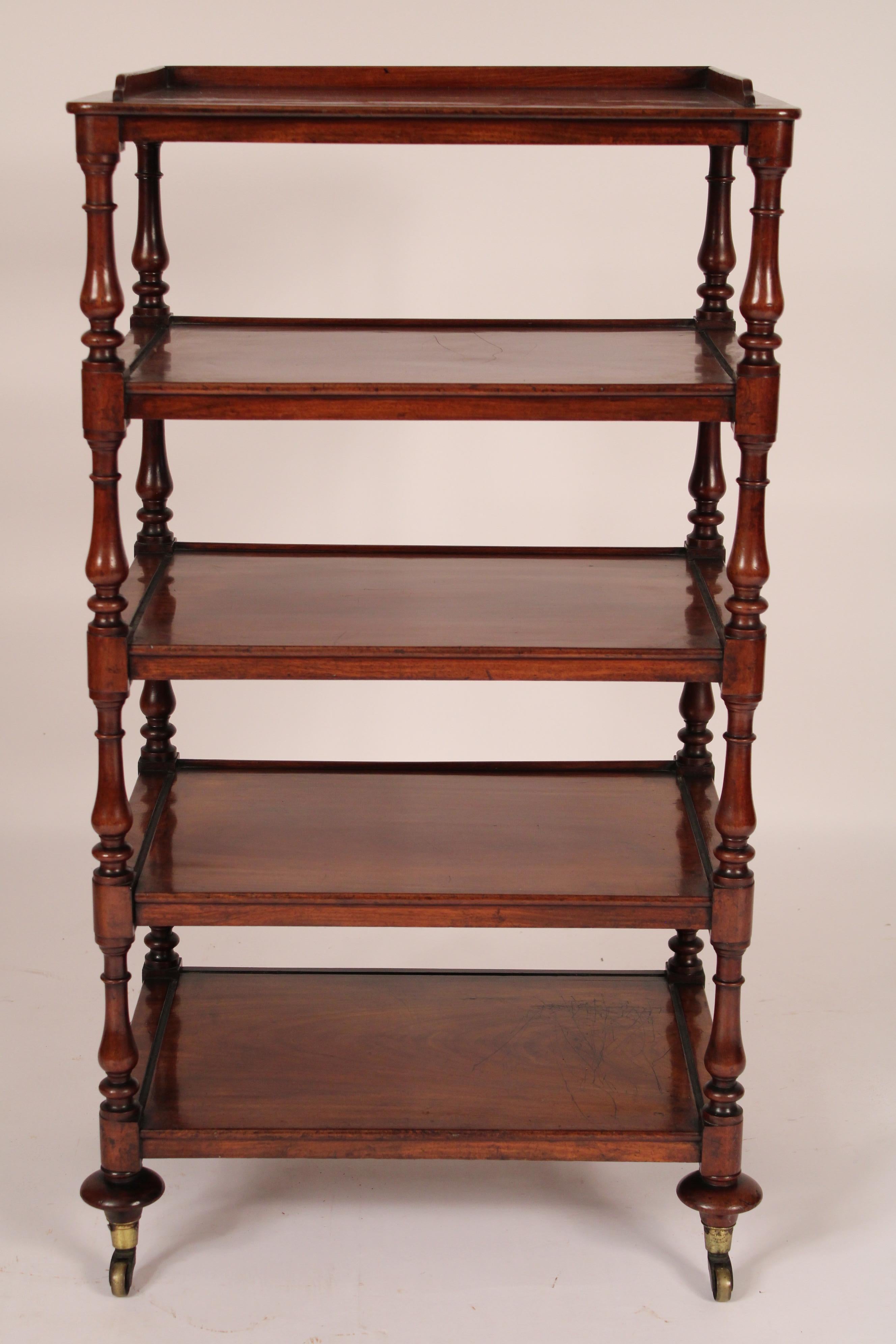 Antique English Regency mahogany 5 tier etagere, 19th century. With 5 tiers supported by baluster and ring turnings, turned legs ending in brass casters. Brass casters indistinctly stamped by maker. Excellent old mahogany color. Distance between
