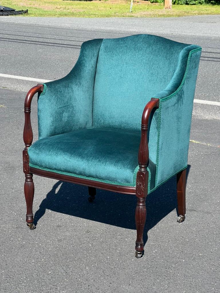 Introducing a charming Antique English Regency Upholstered Living Room Chair, dating back to circa 1820. This exquisite piece is a fine example of Regency-era craftsmanship, combining elegance and comfort in a timeless design.

Crafted from rich