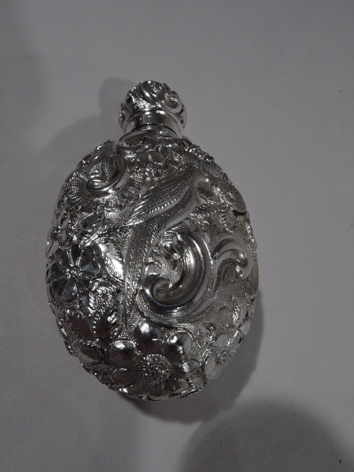 Victorian sterling silver scent bottle, 1889. Ovoid with short neck and threaded ball cover. Allover repousse with flowers and scrolls. A peacock on one side, a dove on the other. Pretty and portable. Worn marks including London assay stamp.  
