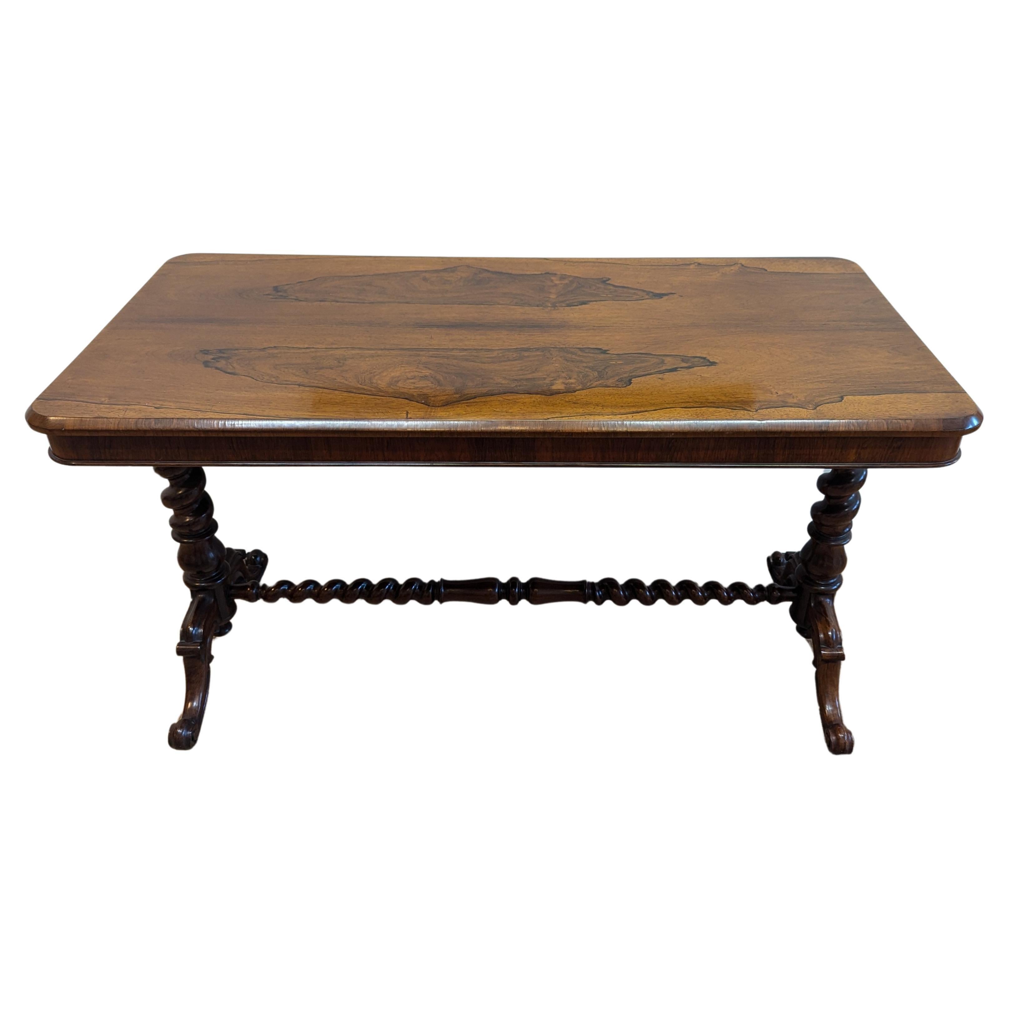 Beautiful Antique English Rosewood Console Table with Twist Legs and center strut also referred to as a Library Table.  The top has wonderful Rosewood bookmarked veneers with banded rolled beveled edge atop a banded apron. Trestle Twist legs with