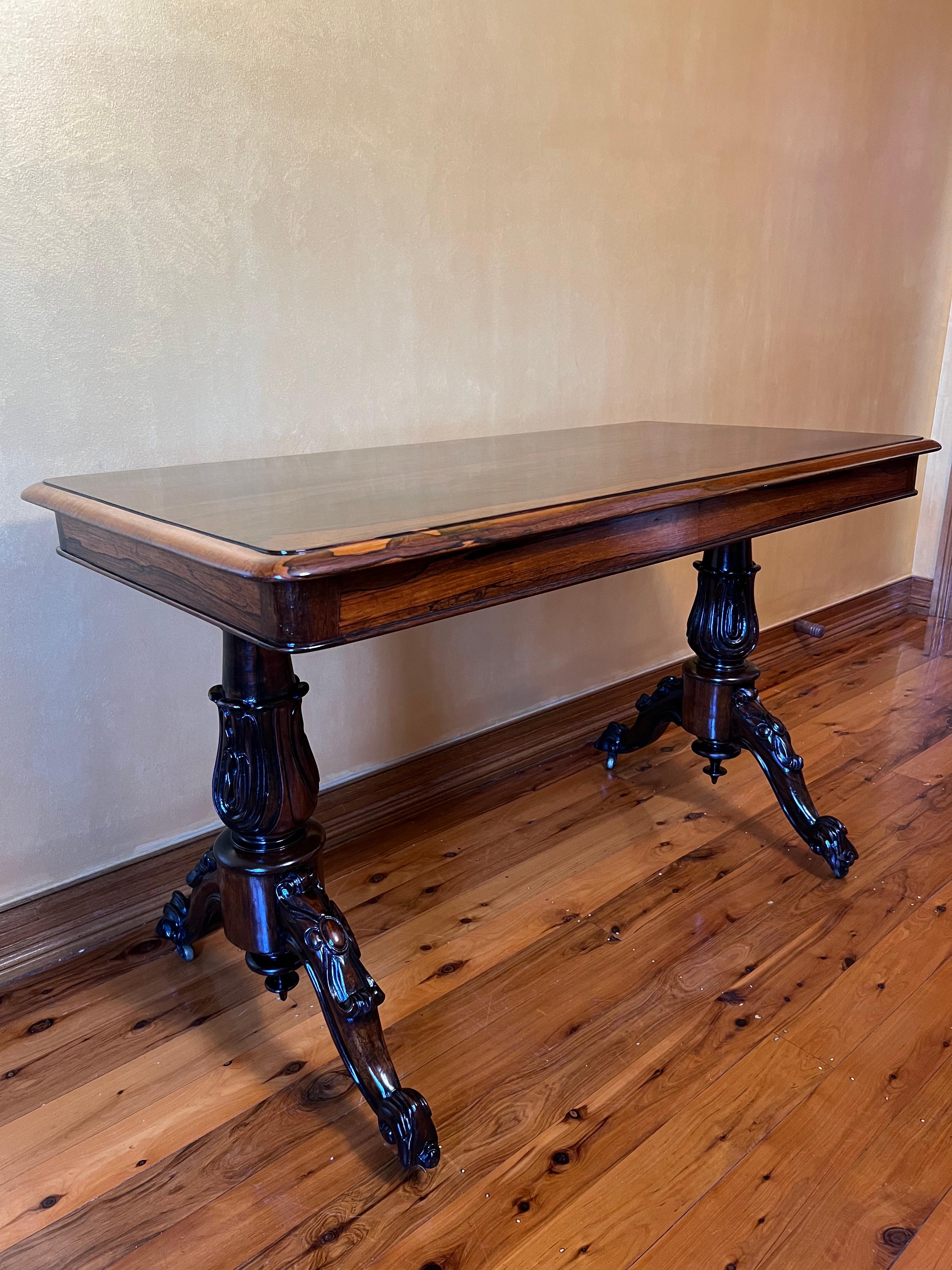 Smooth gloss table top finish, detailed carvings to legs and feet of table, comes with castors.

circa: 1870

Material: Rosewood

Country of Origin: England

Measurements: 73cm high, 63cm width, 121cm length

Pick Up Location at: 64 Kalang
