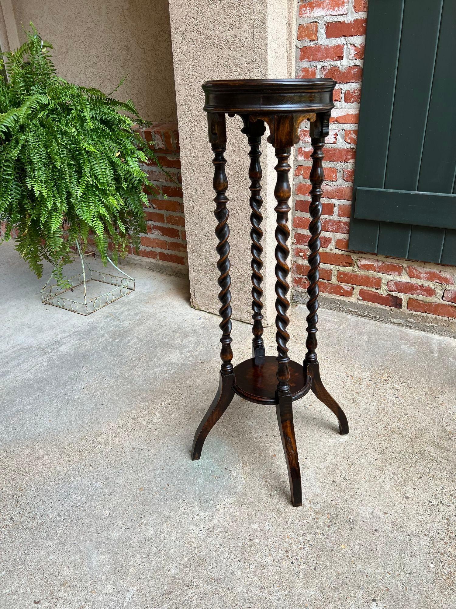 Antique English Round Plant Stand Barley Twist Dark Oak Jardiniere Display Table.

Direct from England, a very tall and quite lovely antique English plant or display stand. Round beveled top over a thick apron with arched and scalloped trim around