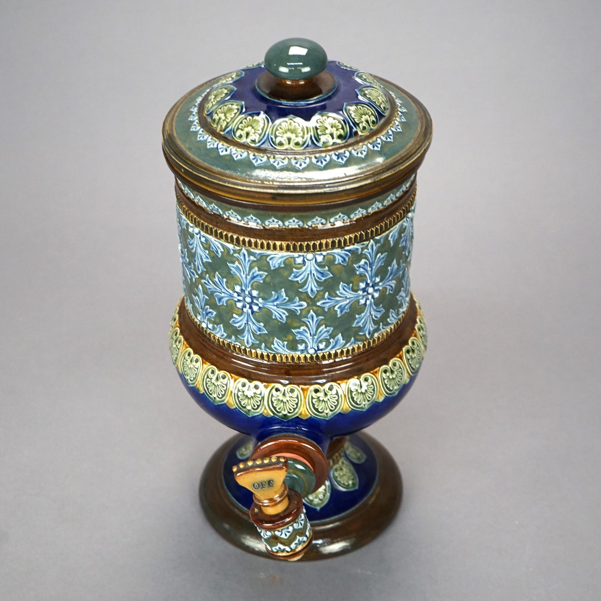 An antique English beverage dispenser by Royal Doulton offers pottery construction with polychrome glazed exterior, raised on pedestal base, circa 1890

Measures- 14''H x 6.75''W x 9.25''D.