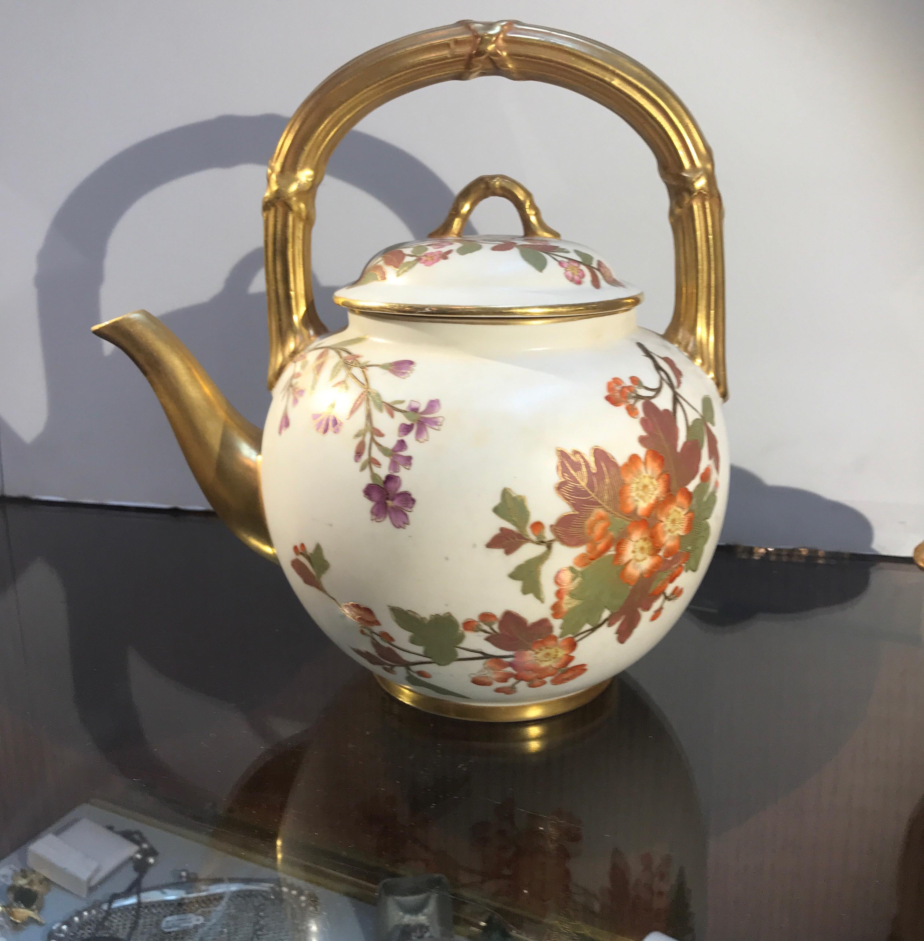 Beautiful hand painted porcelain tea set by Royal Worcester, England. The hand painted floral decoration with gilt trim and handles. Each piece is year marked for 1889 and represents the Aesthetic Movement of the 19th century.
Teapot is 8