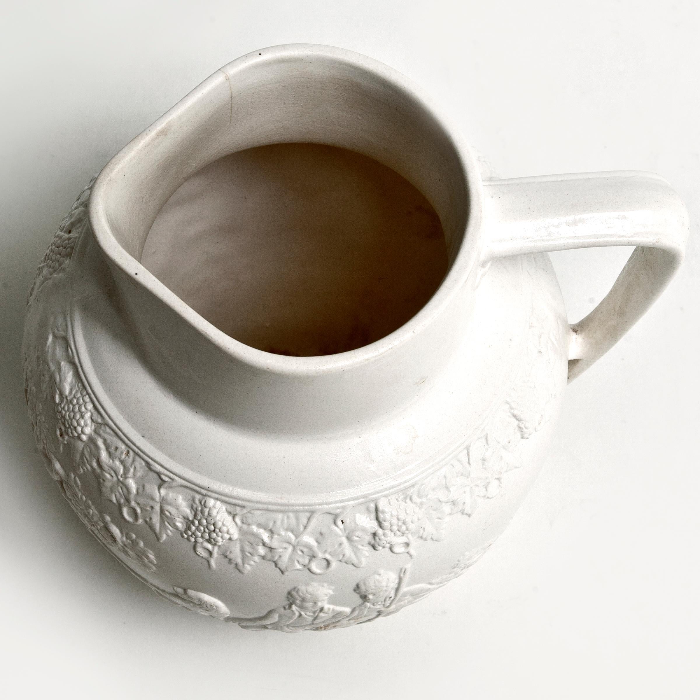 Rare antique salt-glazed stoneware pitcher with hunting scene. Slight discoloration around the base.