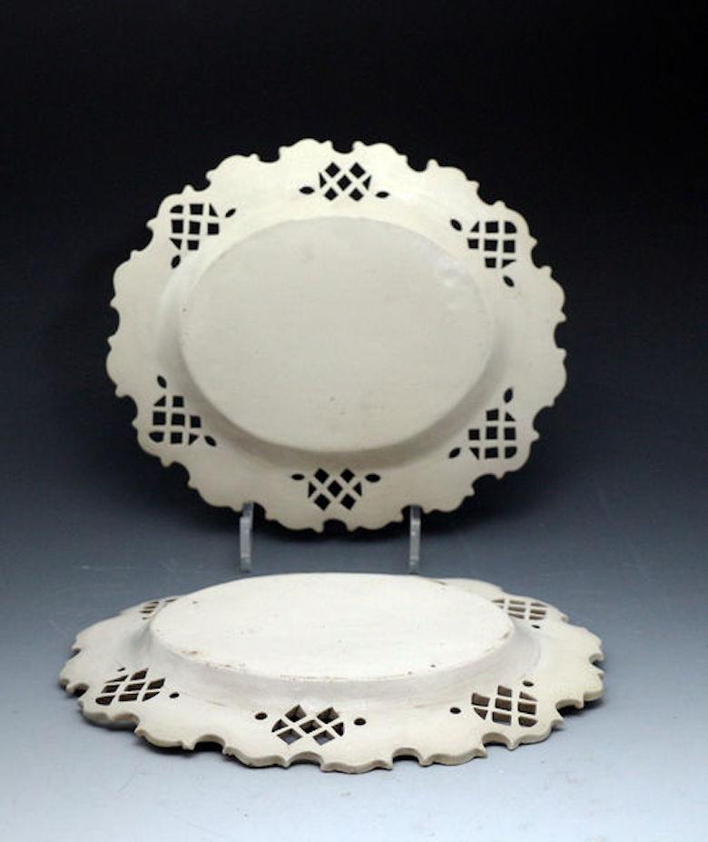 A pair of Staffordshire saltglaze stoneware pottery oval dishes with relief molded decoration of acorns inside a lattice basket weave pierced border. The dishes are in remarkable condition and are similar to pieces made at the Whieldon Pottery in