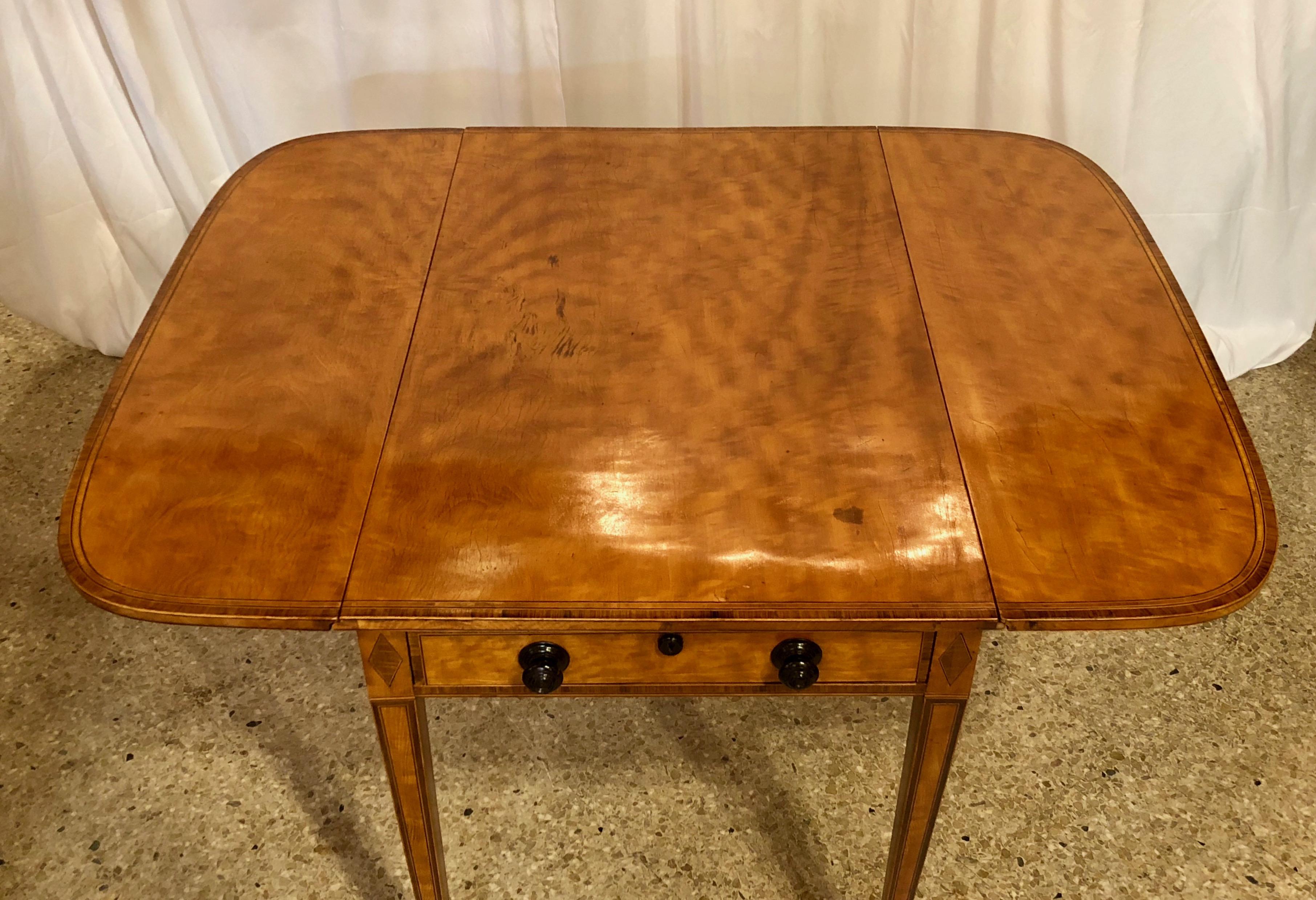 This handsome satinwood table with its warm color is easy on the eyes, and ample enough to use for board games or as a dining table in any room of your choosing.