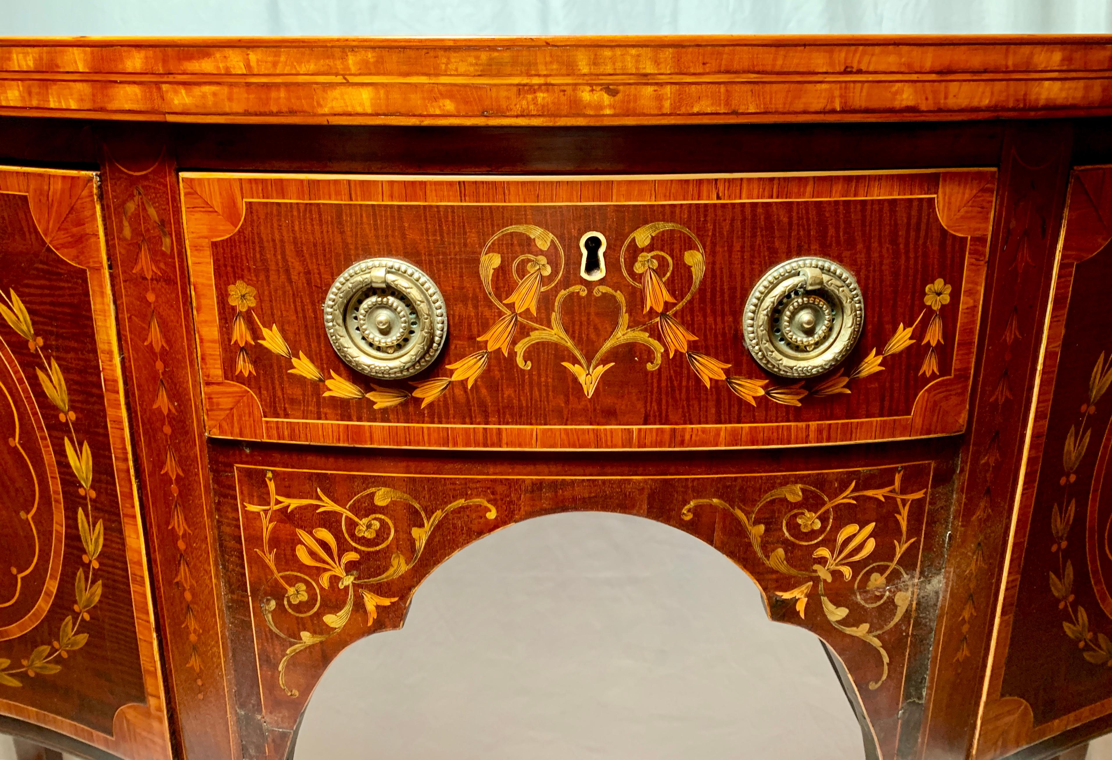 Beautifully inlaid with nice detail, this is a charming sideboard.

