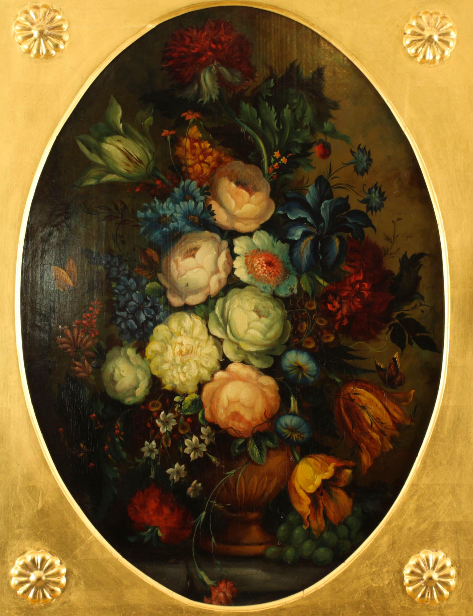 This is a beautiful English School antique oil on panel paintings of a still life, 19th century in date.

The oil on panel painting depdicts a beautiful still life of roses, irises, butterflies and other flowers in an urn. It is signed indistinctly