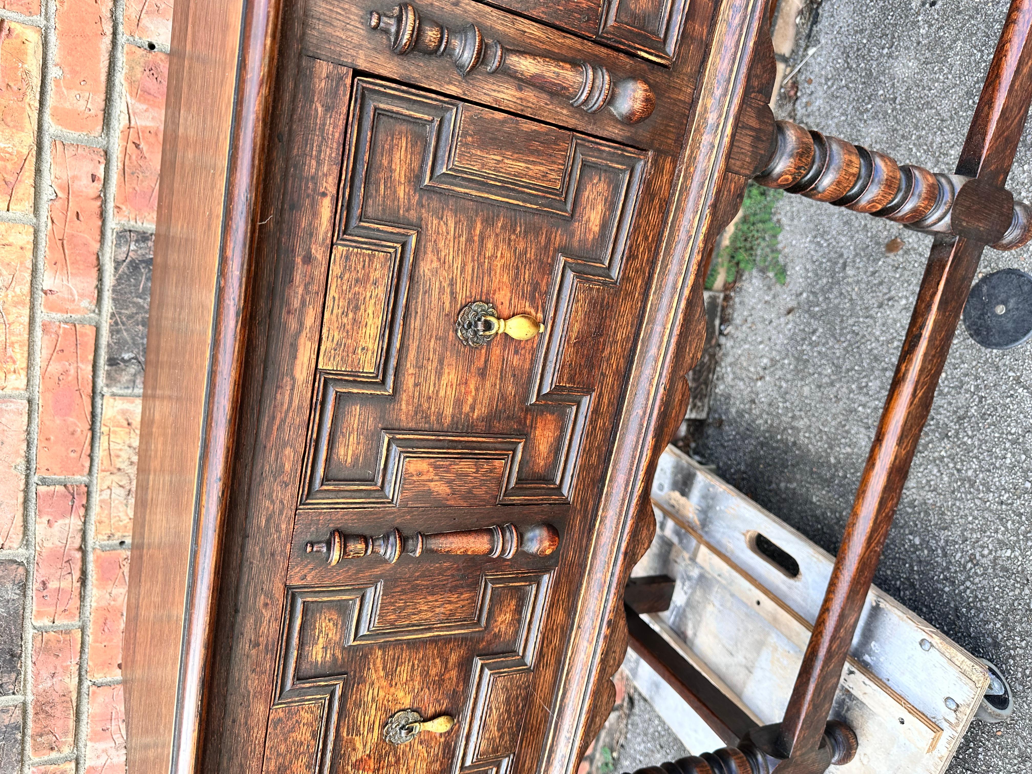 This is a beautiful Jacobean style server with amazing patina and wood color. Features two drawers with lovely geometric designs bobbin twist legs in perfect condition. These things can go many places in the home and have many uses.