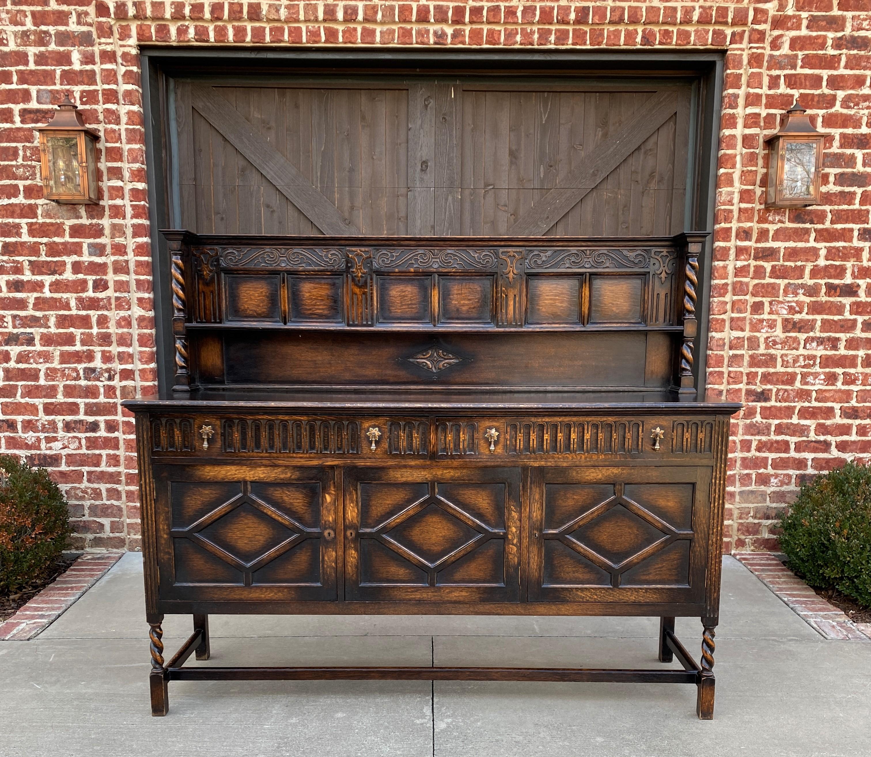 Gorgeous Antique English oak Jacobean barley twist server, sideboard or buffet with center drawers and lower cabinets~~c. 1890s


Full of character and classic English style sideboard or server with barley twist legs and upper posts~~fill it with