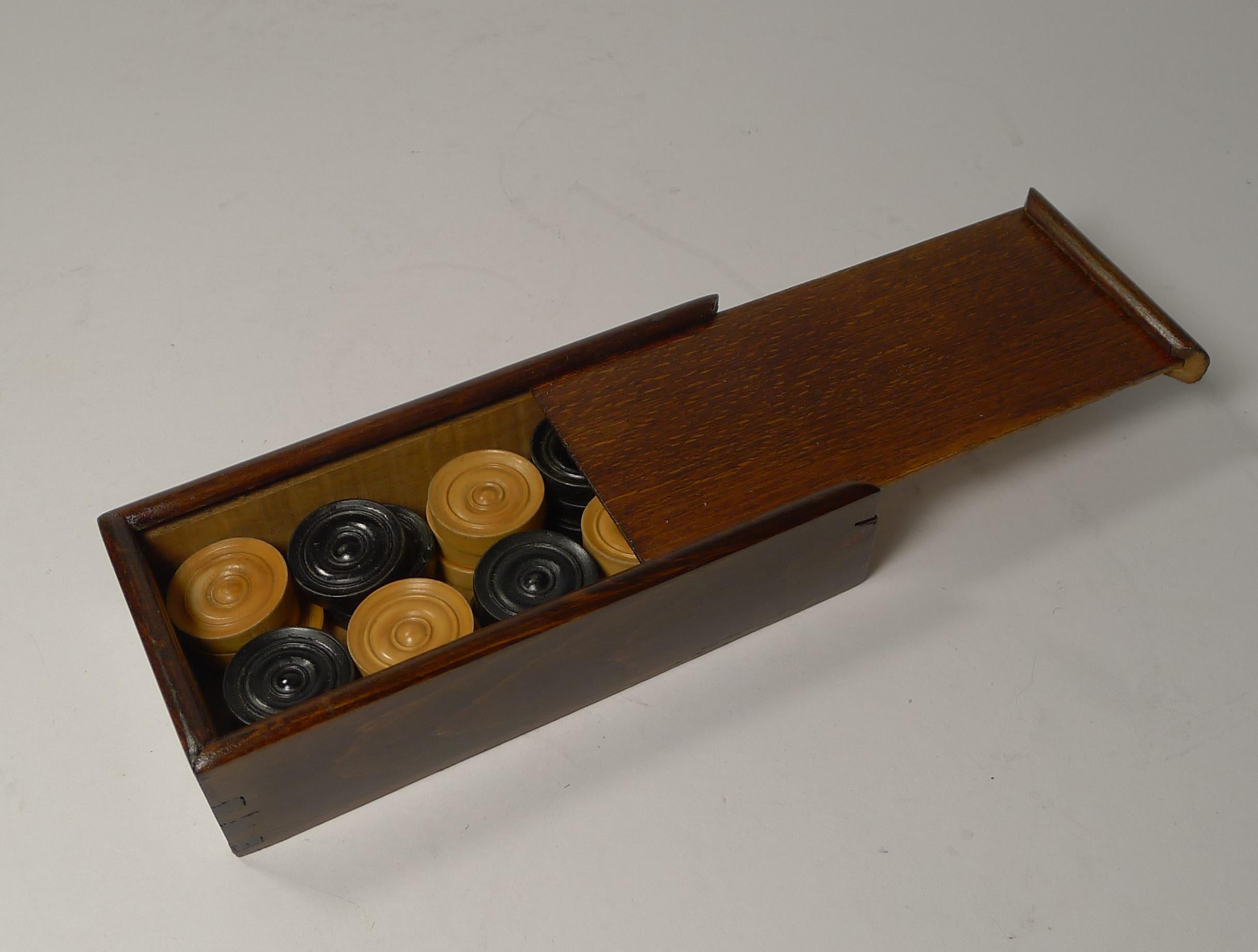 Rather unusual, this set is smaller than most found and would suit a smaller games or backgammon board. 

A fabulous boxed set of late Victorian or early Edwardian games counters, perfect for Draughts or Backgammon.

The set is complete and