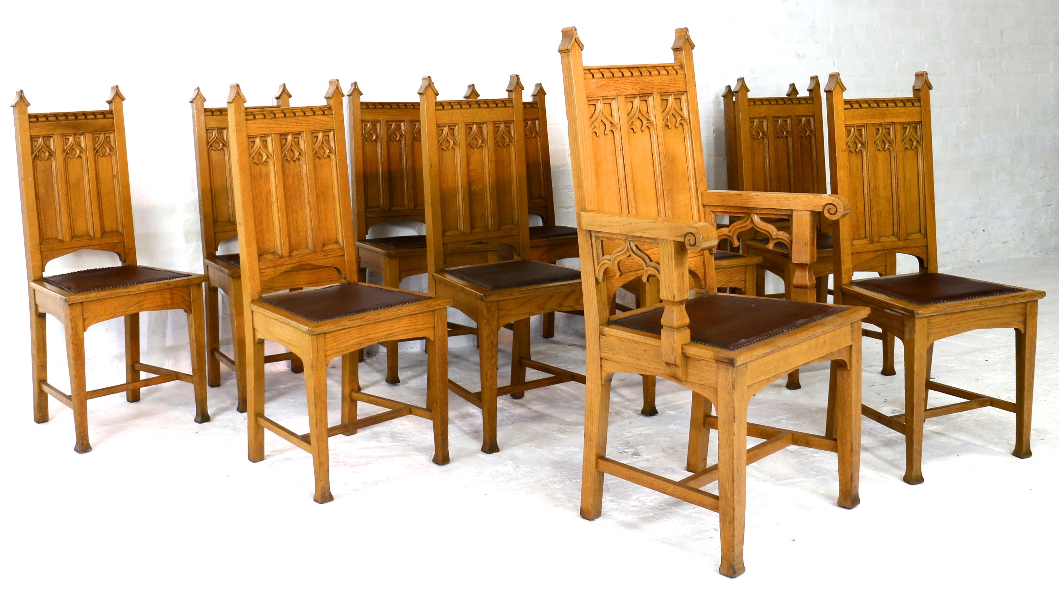 A super set of twelve Gothic Revival Arts & Craft oak dining chairs attributed to Shapland & Petter and dating to circa 1880. Ideal for any a church conversation they feature pointed arches and panelled backs with Gothic arch and trefoil tracery,