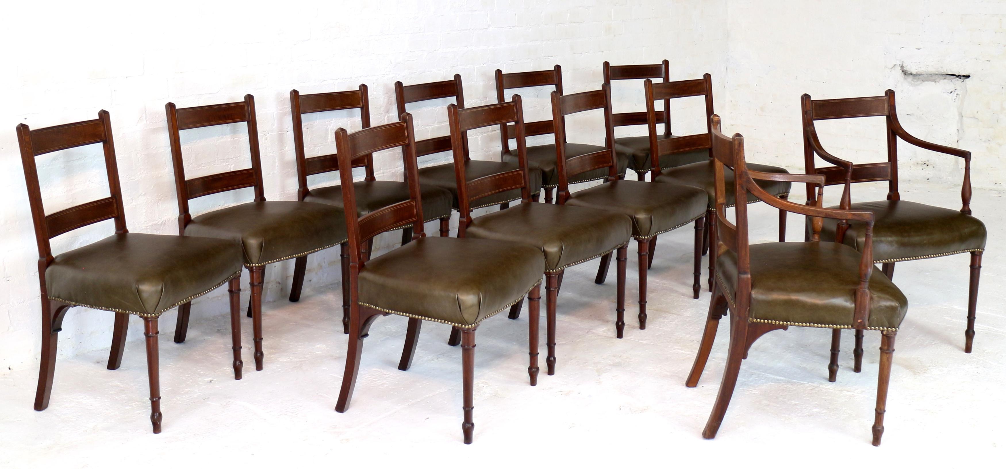 A rare set of twelve George III mahogany tablet-back dining chairs attributed to Gillows of Lancaster and dating to circa 1790. Comprising two carver armchairs and ten side chairs, the backs with box and ebony strung fiddleback mahogany rails