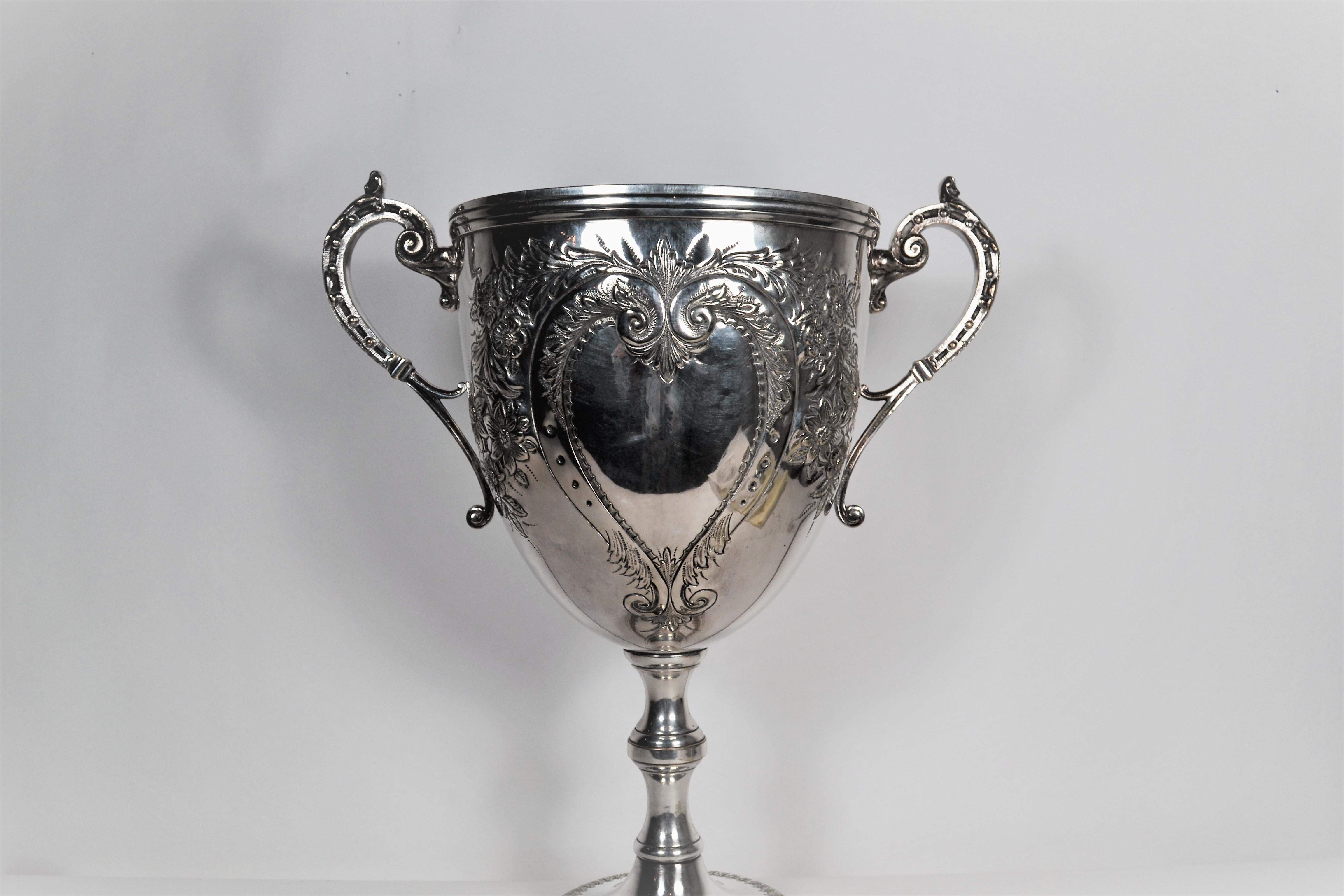 This lovely trophy cup has ample room for an inscription on the center heart of the piece.  It is a grand size and will make quite the statement!