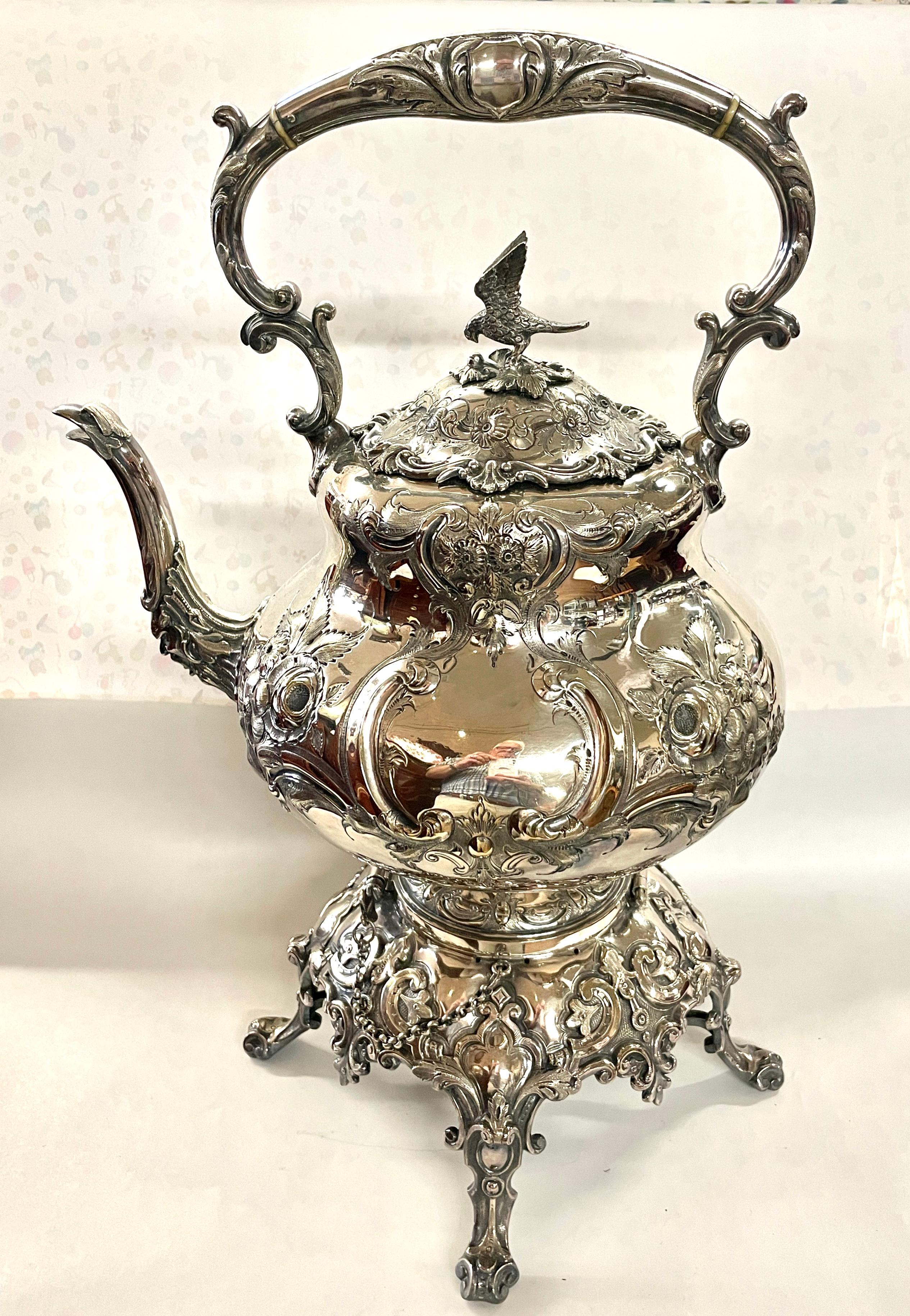 The FINEST Antique English Sheffield Silver Plate Louis Quatorze (XVI) Style Large Size Tipping Kettle on Stand.  The Kettle retains its original pins and chains for allowing the Kettle to be stationary or one pin can be removed to tip the kettle