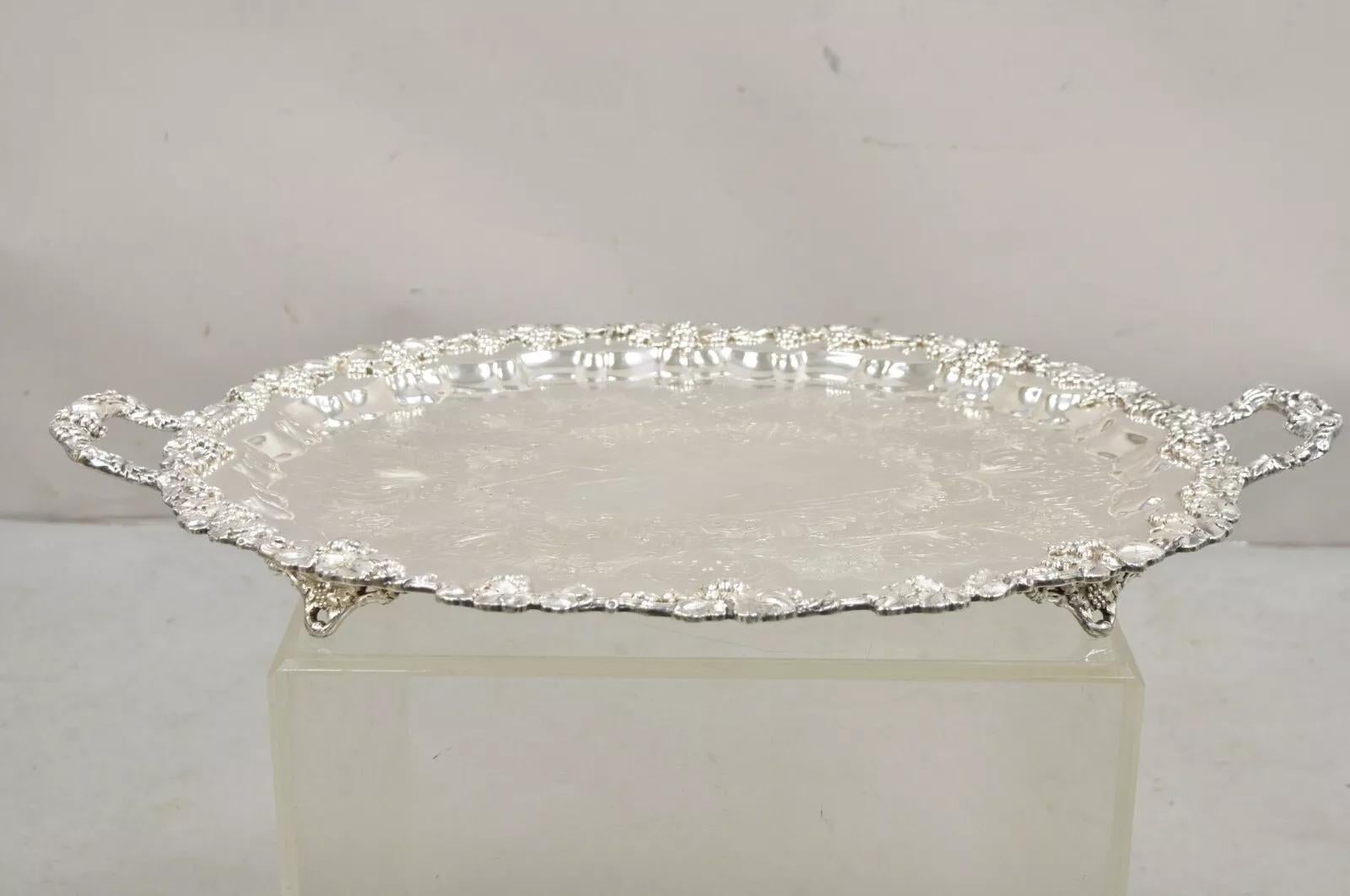 Antique English Sheffield Victorian Grapevine Repousse Oval Serving Platter Tray. Item features a footed base, leafy floral etchings, grapevine border, original hallmark. Circa Early 20th Century . Measurements: 2