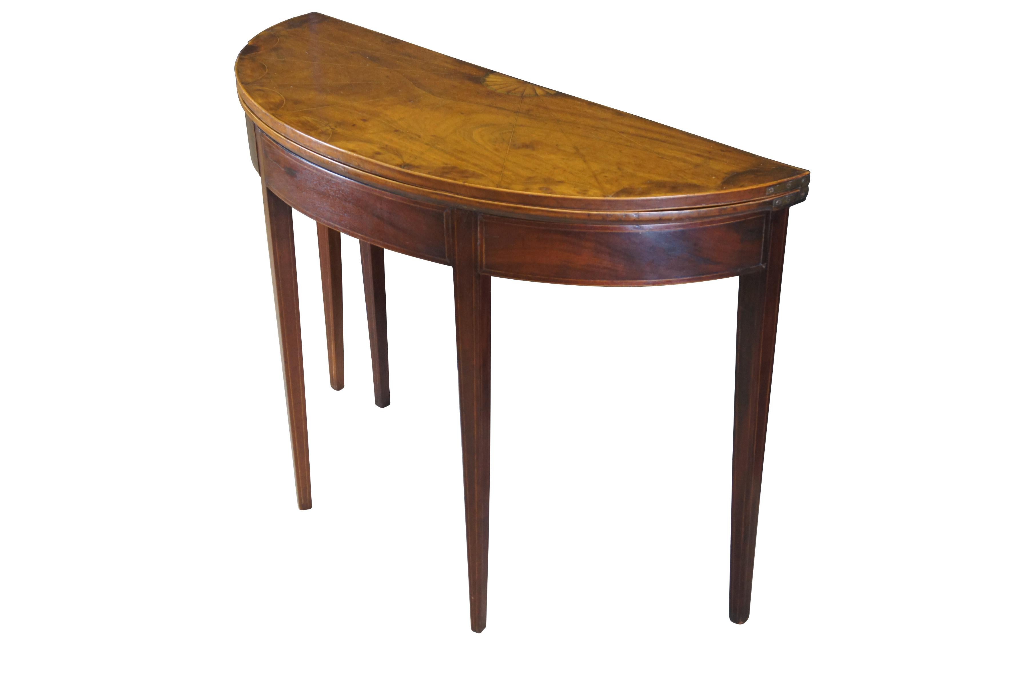 Antique late 18th early 19th century Sheraton period mahogany card / console / tea table.  Made of mahogany featuring inlaid fruitwood shell and web design top which opens to an oval green felt playing surface, supported by tapered legs.  Circa