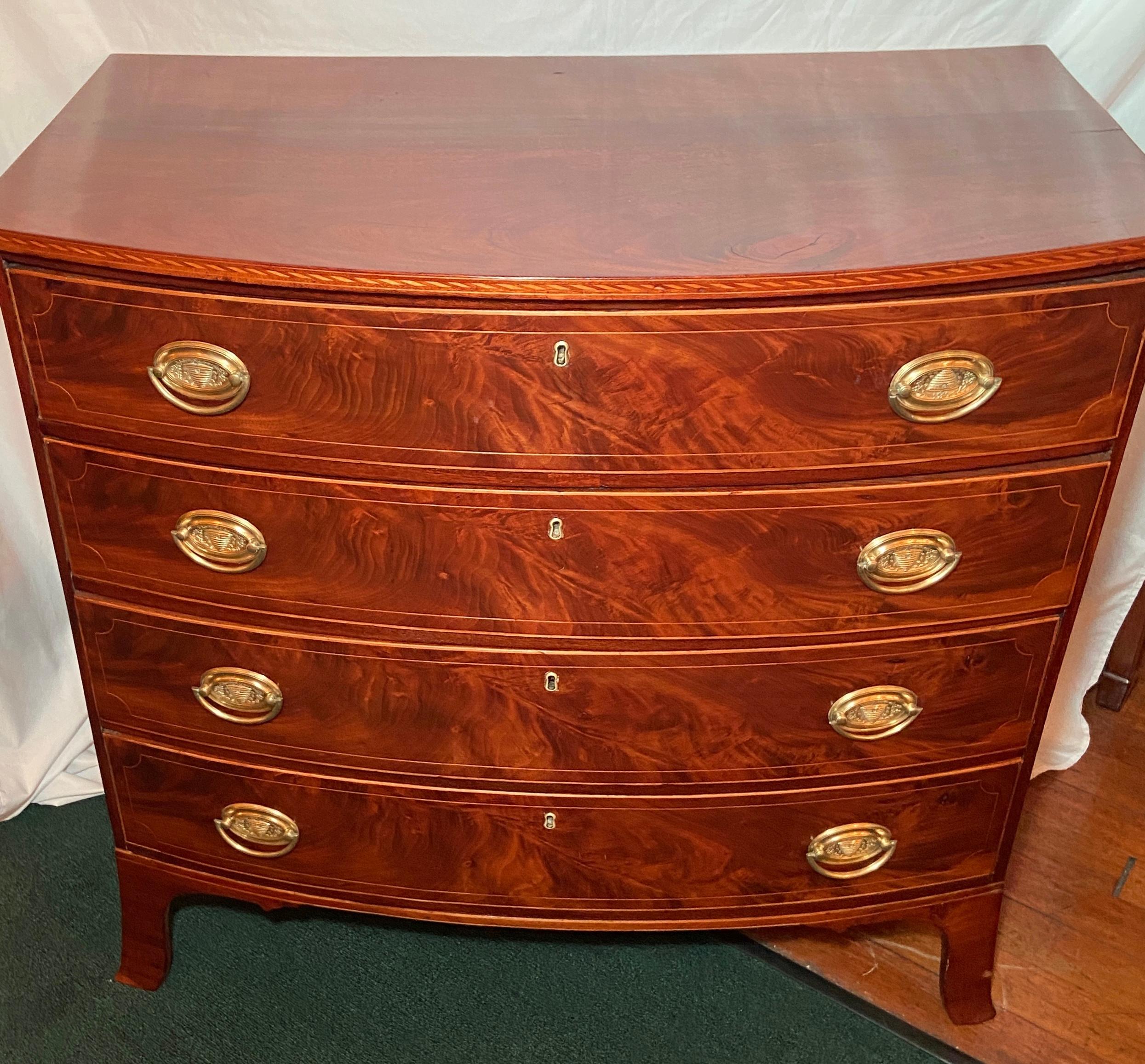Antique English sheraton period bow-front chest of drawers, circa 1810-1820.