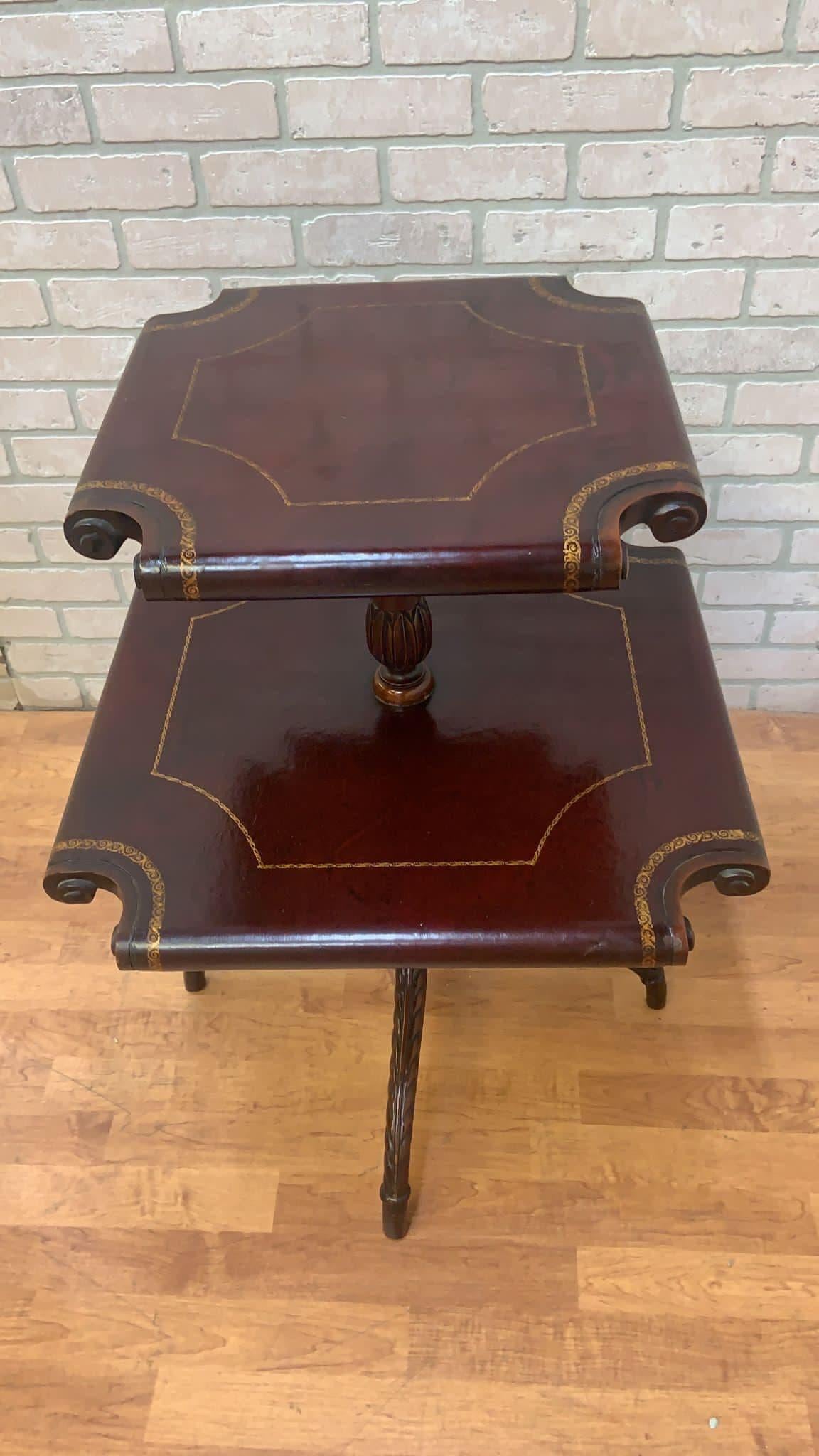 Antique English Sheraton Style Scrolled & Carved Mahogany Two-Tier Tooled Leather Wrapped Side Table

This antique English Sheraton style side table is a captivating and finely crafted piece of furniture, showcasing the elegance of the Sheraton