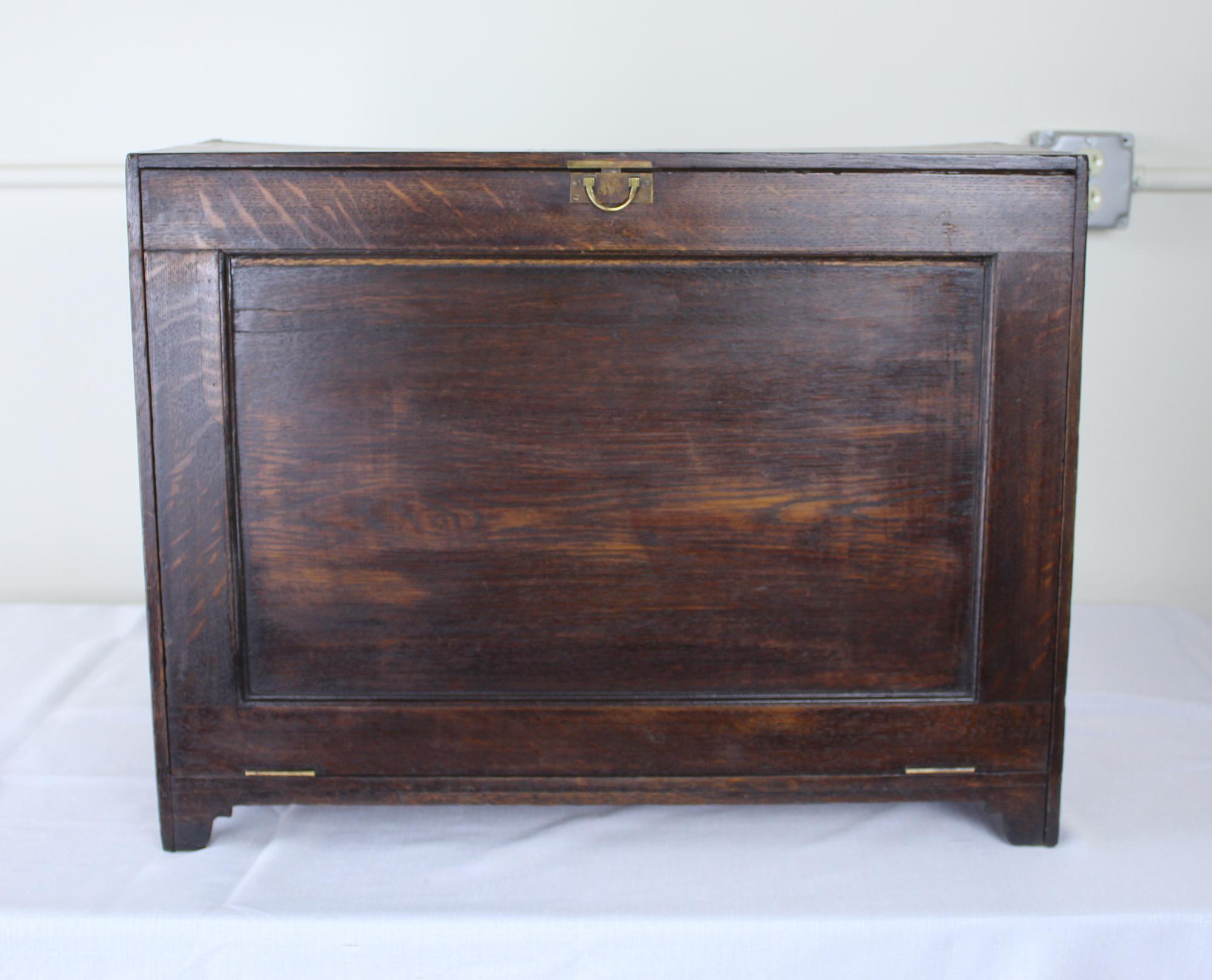 An antique oak shoe box, portable for travel. Nice brass latch and interior bars to accommodate approximately 8 pairs of shoes.