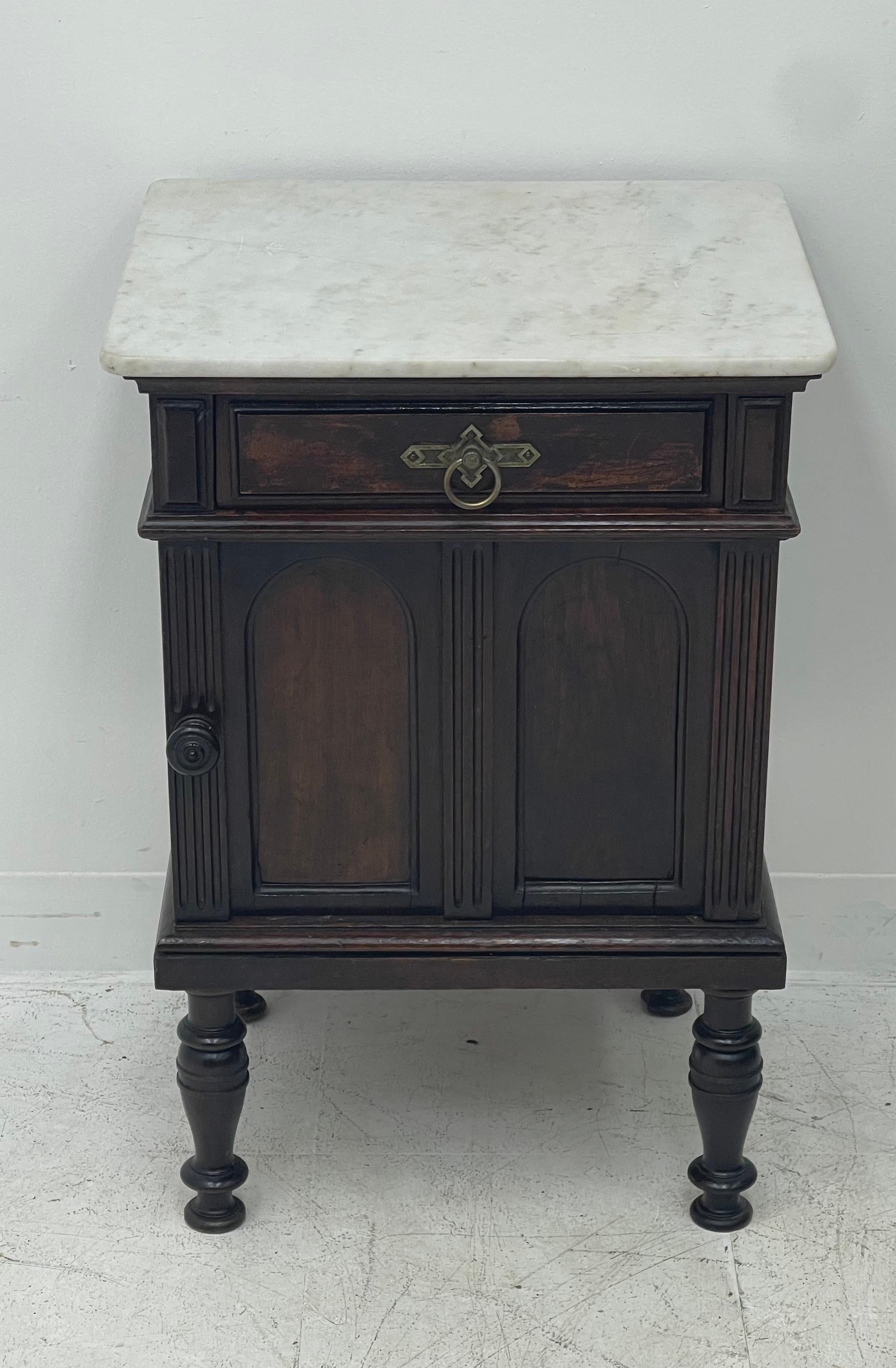 This is an antique bedside cabinet, an English, Arts and Crafts, Maple and Co., cupboard. A nightstand in mahogany dating to the late 19th century, circa 1890. 
In good proportion and classic Maple and Co, Arts and Crafts styling. Select mahogany