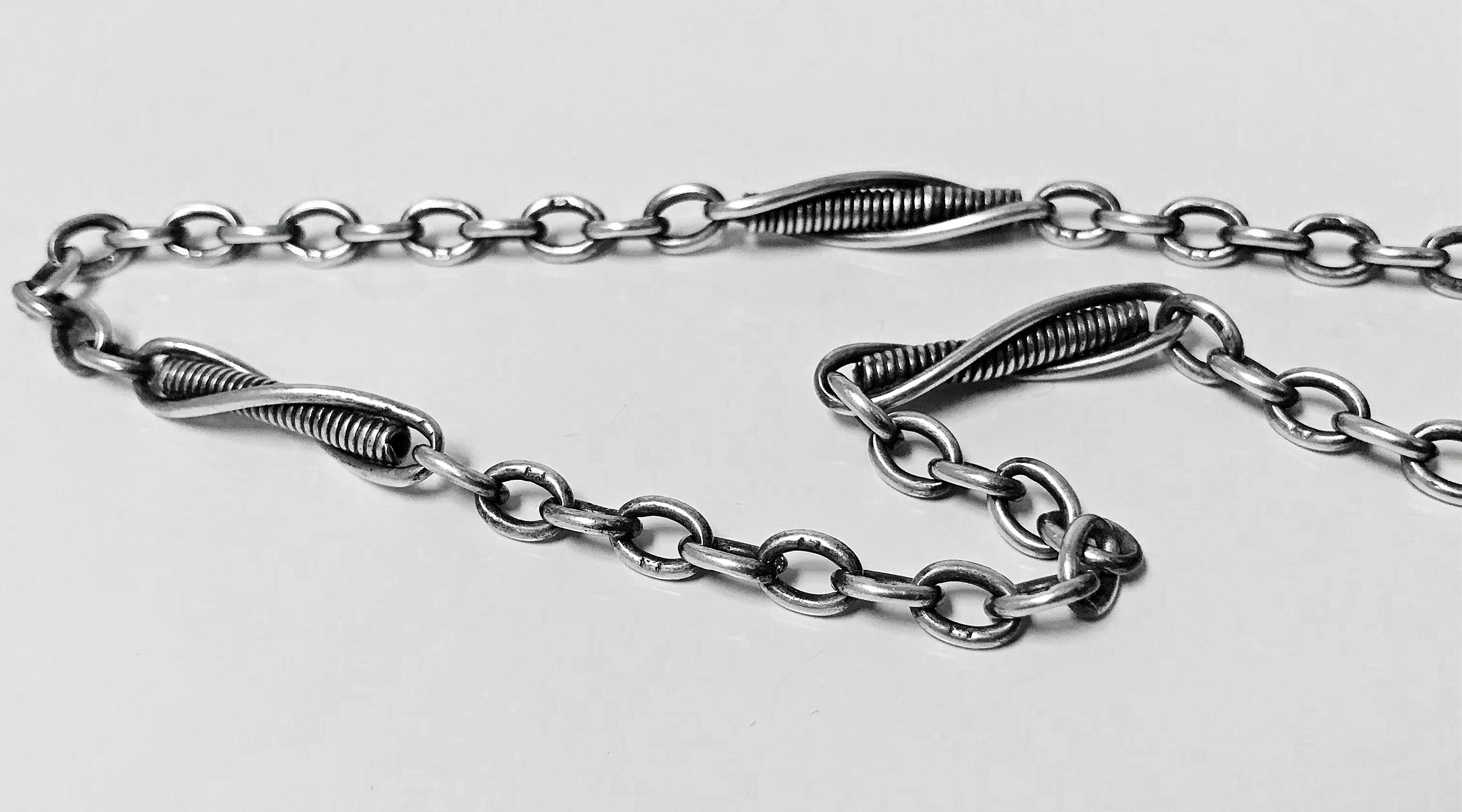 Antique English Silver Albert Watch Chain, Birmingham 1908 Henry Pope. Oval intertwining links interspaced with spiral twist groove design sections. T bar, two swivels and all links hallmarked. Length: 15.5 inches. Item Weight: 24 grams.