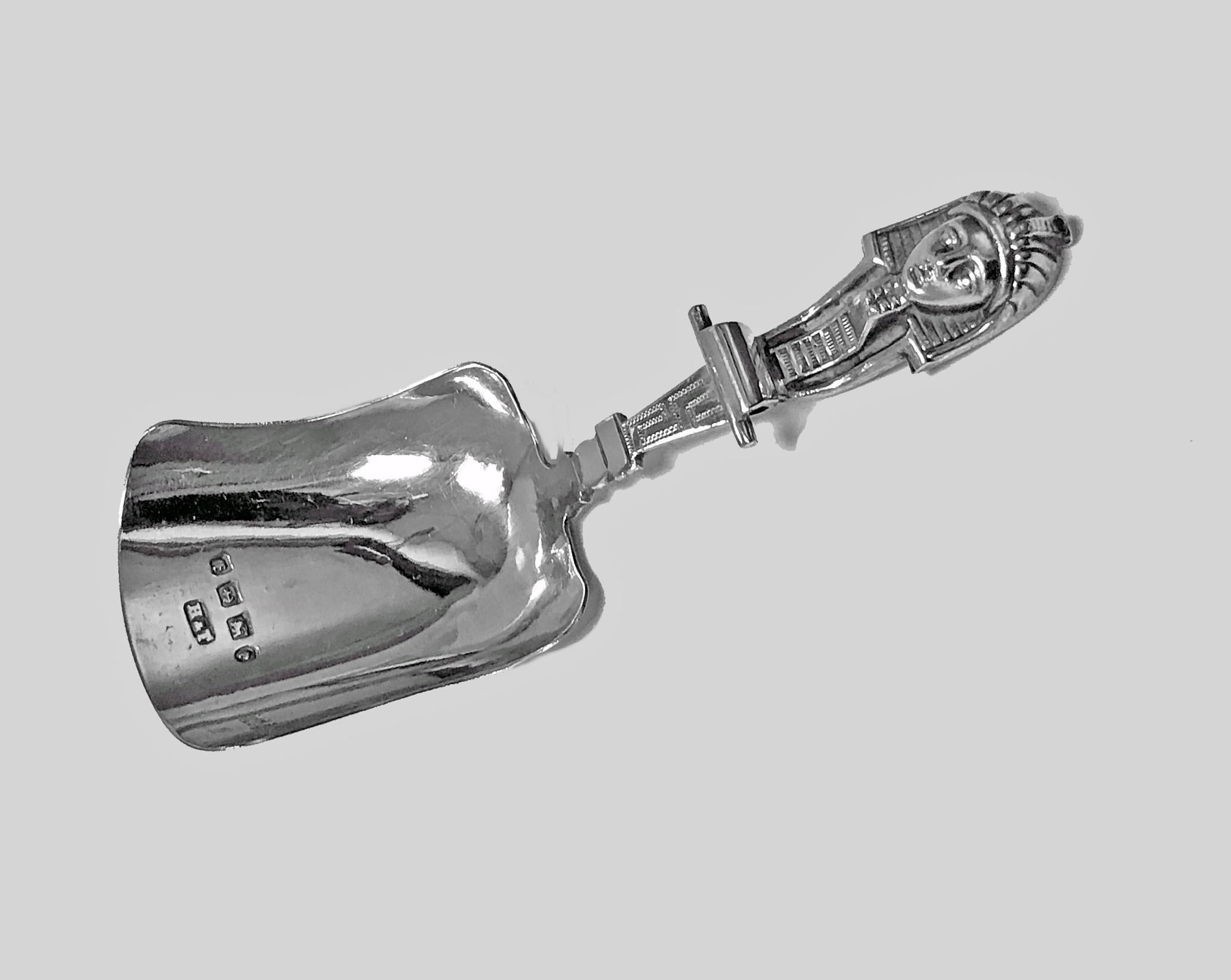 Antique English silver caddy spoon pharaoh head, Birmingham 1880 Hilliard & Thomason. Shovel form with unusual head of a pharaoh. Fully hallmarked. Length: 3.5 inches. Weight: 11 grams.