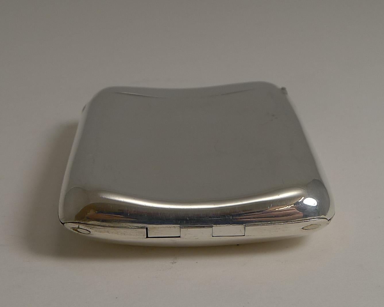 A most unusual small visiting card case featuring a concealed integral photograph / Picture frame.

The solid sterling silver case is shaped to fit more comfortably in a pocket. Visiting cards in the Victorian era were smaller than modern business