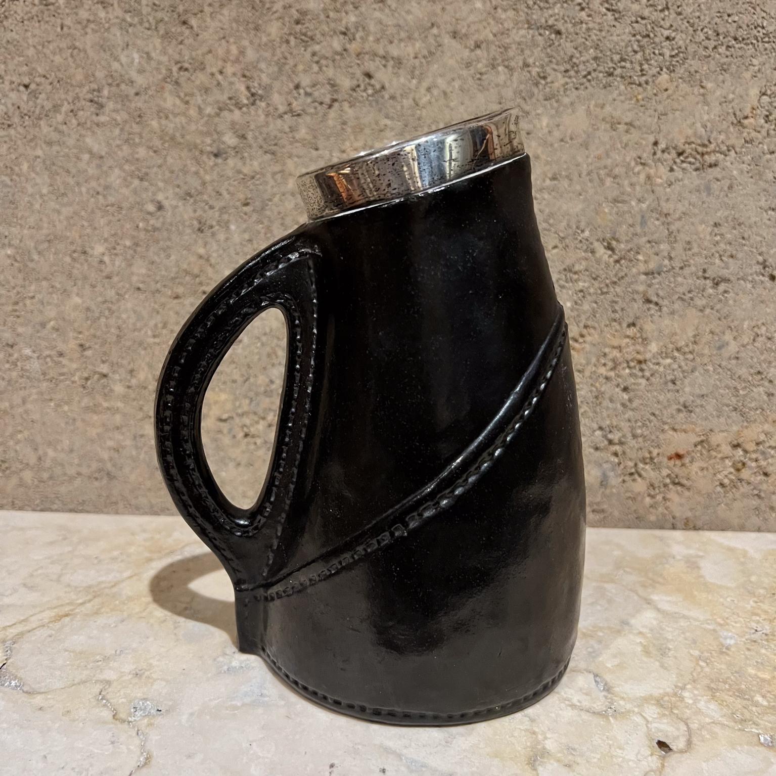 AMBIANIC presents
Late Victorian Silver Mounted Ceramic Pottery Blackjack Pitcher
Doulton Lambeth mark of Saunders & Shepherd London 1894
7 h x 5.25 d x 3.5 w
Preowned original vintage condition
Patinated wear.
See all images for details.