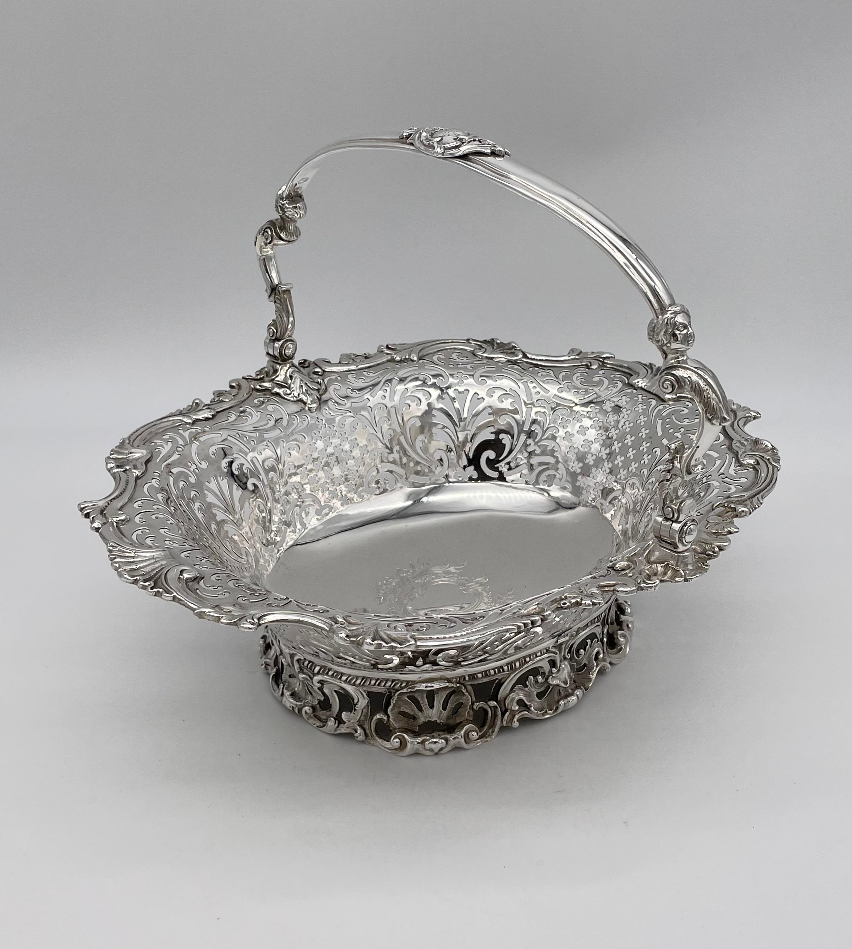 A George II sterling silver bread basket, London 1750 by Samuel Herbert & Co
Of shaped oval form in the Rococo style, all raised upon a cast scallop shell and C scroll foot. The rim formed as splayed shells and acanthus scrolls, the swing handle