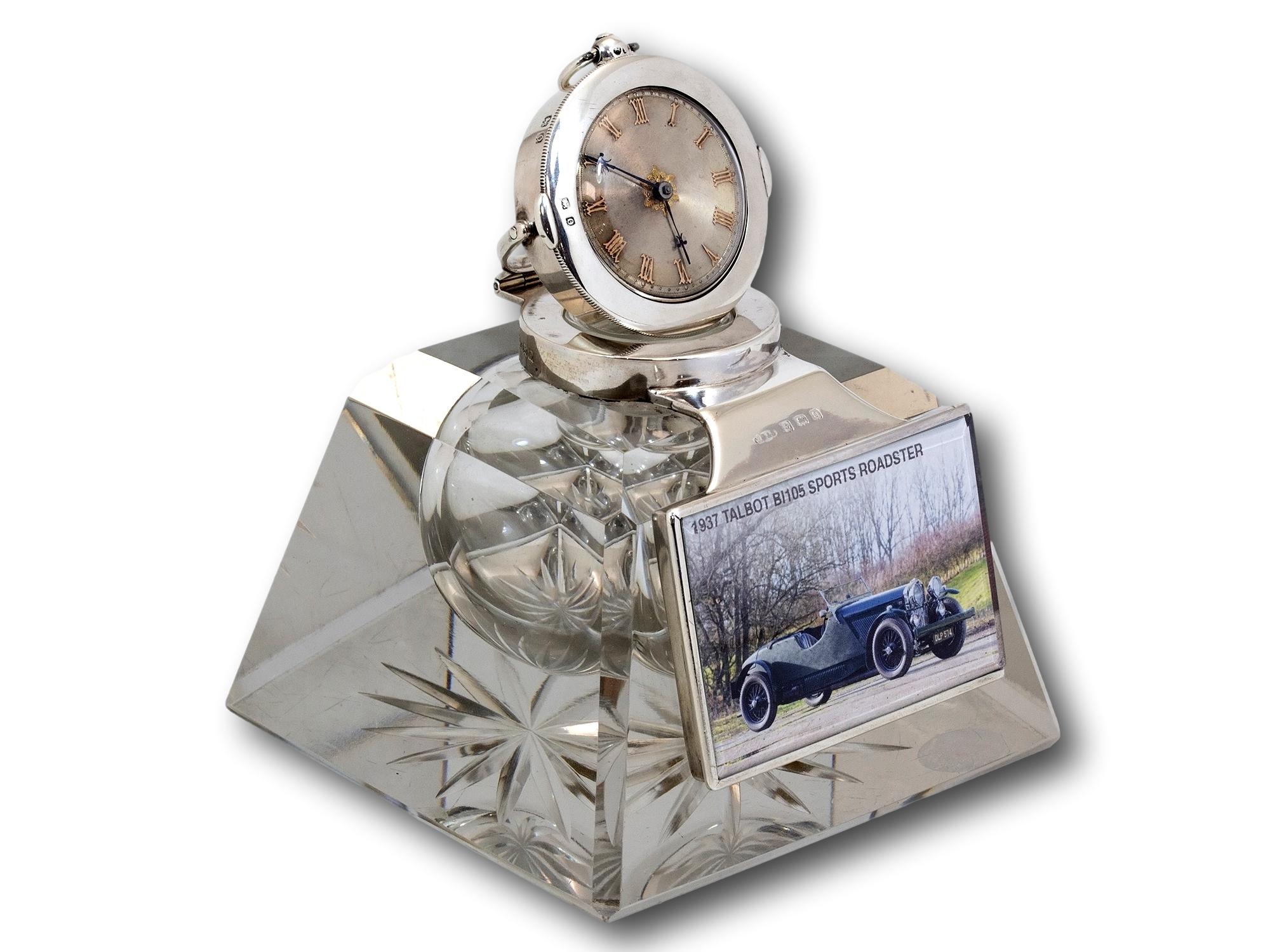 Changeable picture frame to the front 

From our accessories collection, we are delighted to offer this Silver Mounted Desk Inkwell and Clock. The Desk Inkwell of pyramid shape with a cut glass star base mounted in sterling silver with a travel