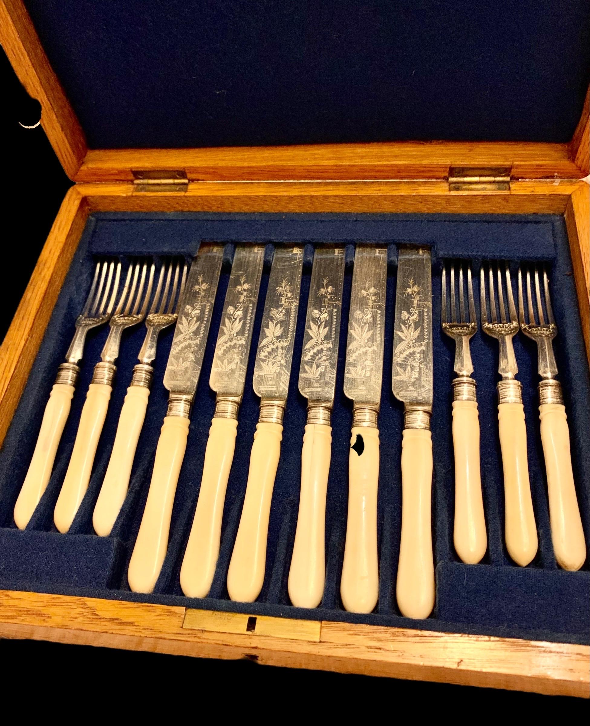 An antique English Edwardian silver-plate fish set for six in the Anglo Japanese style having Bakelite handles and lovely engraving of Japanese fans and flora, all encased in a solid oak presentation box with cobalt blue velvet lining.

Both