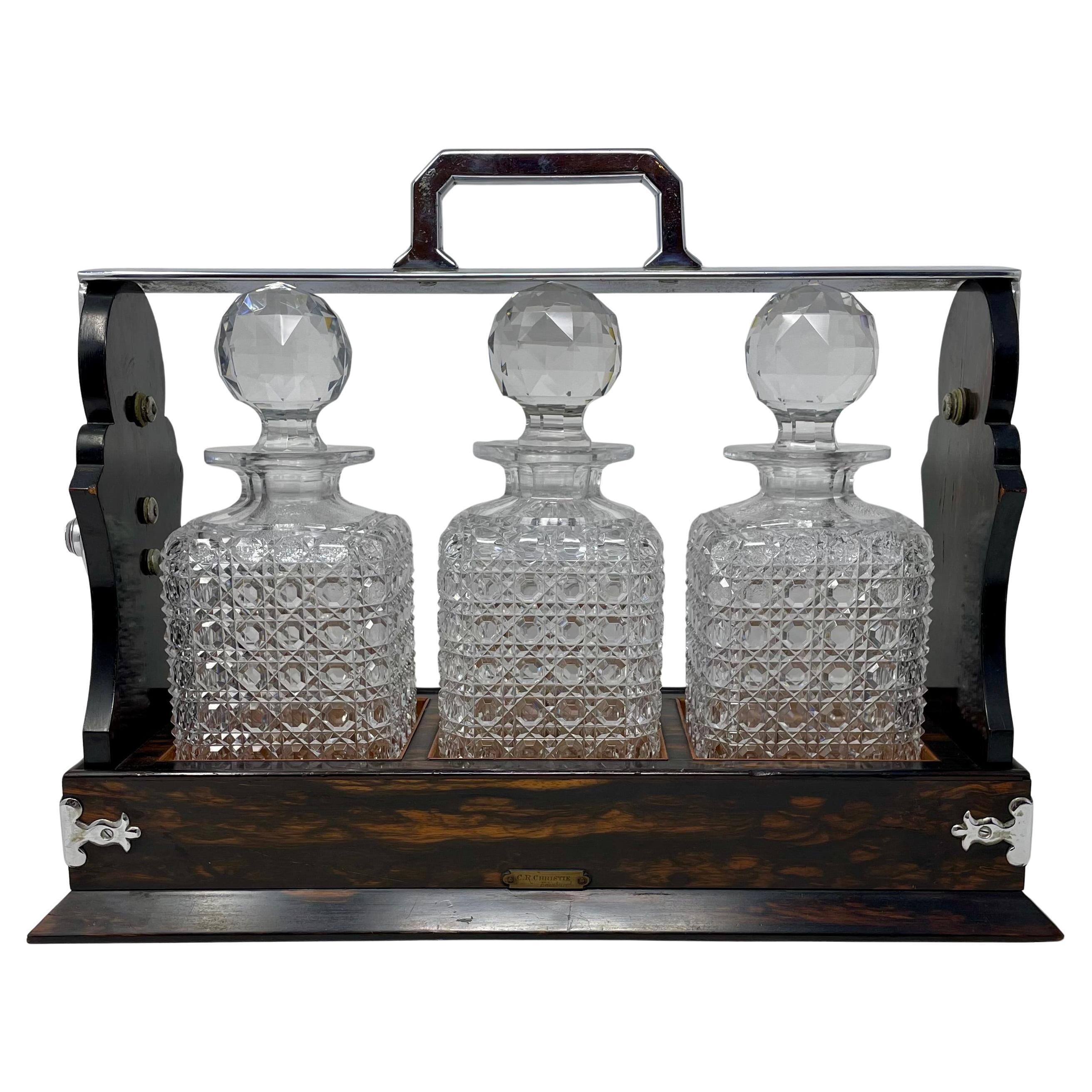 Antique English Silver Plate Mounted Coromandel Wood and Cut Crystal Three Bottle Tantalus, Circa 1890's.