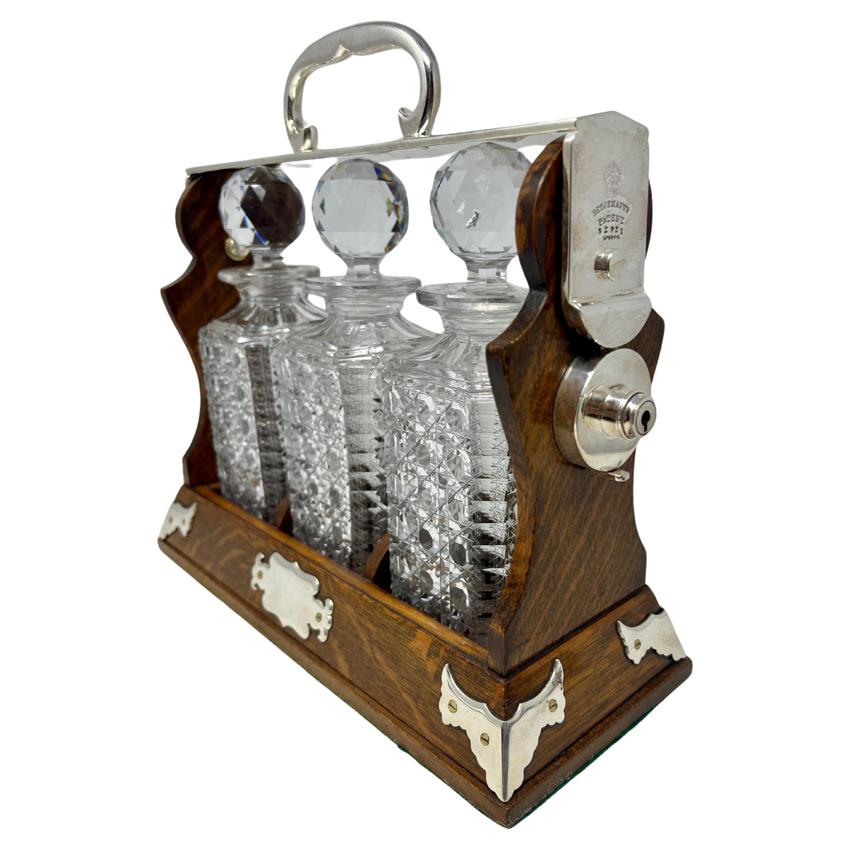 Antique English Silver-Plate & Golden Oak Three Bottle Tantalus, Circa 1880. In Good Condition In New Orleans, LA
