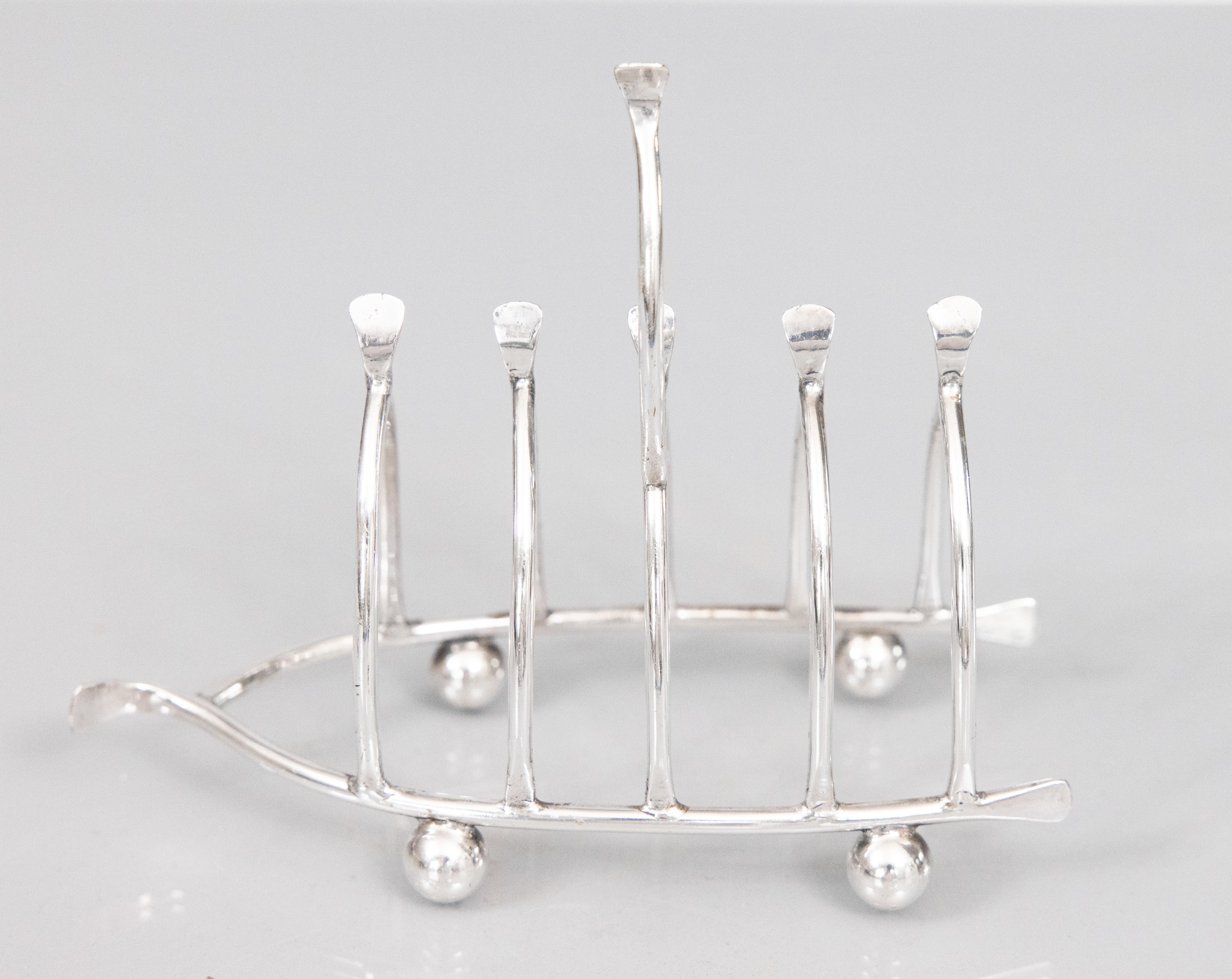 A lovely rare antique English silver plate wishbone shaped novelty toast rack with charming ball feet. Hallmarks on reverse. It would be wonderful for serving toast or could also be used as a letter holder.

Dimensions
6ʺW × 2.5ʺD × 4.75ʺH
