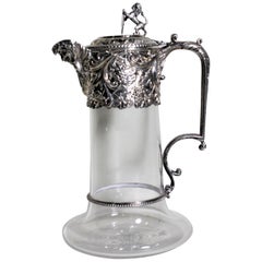 Ancienne carafe à claire-voie en verre taillé et plaqué argent.