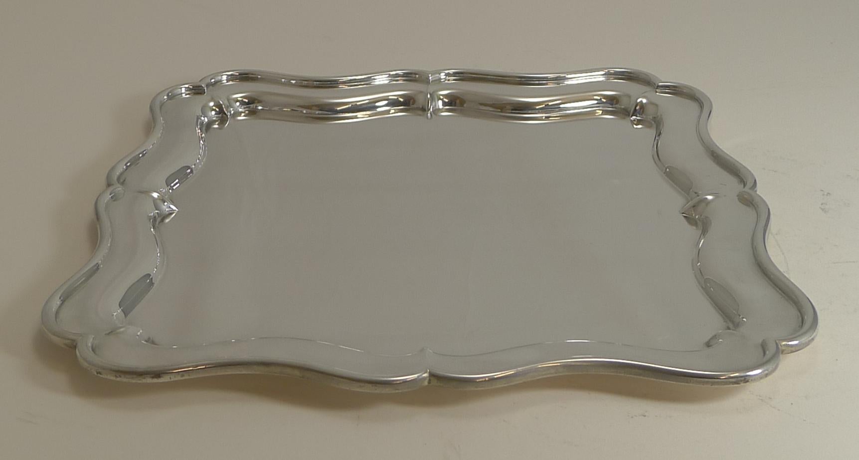 A very smart, quality silver plated tray or salver, square in form with attractive shaped border.

The underside is signed by the well renowned silversmith, 
