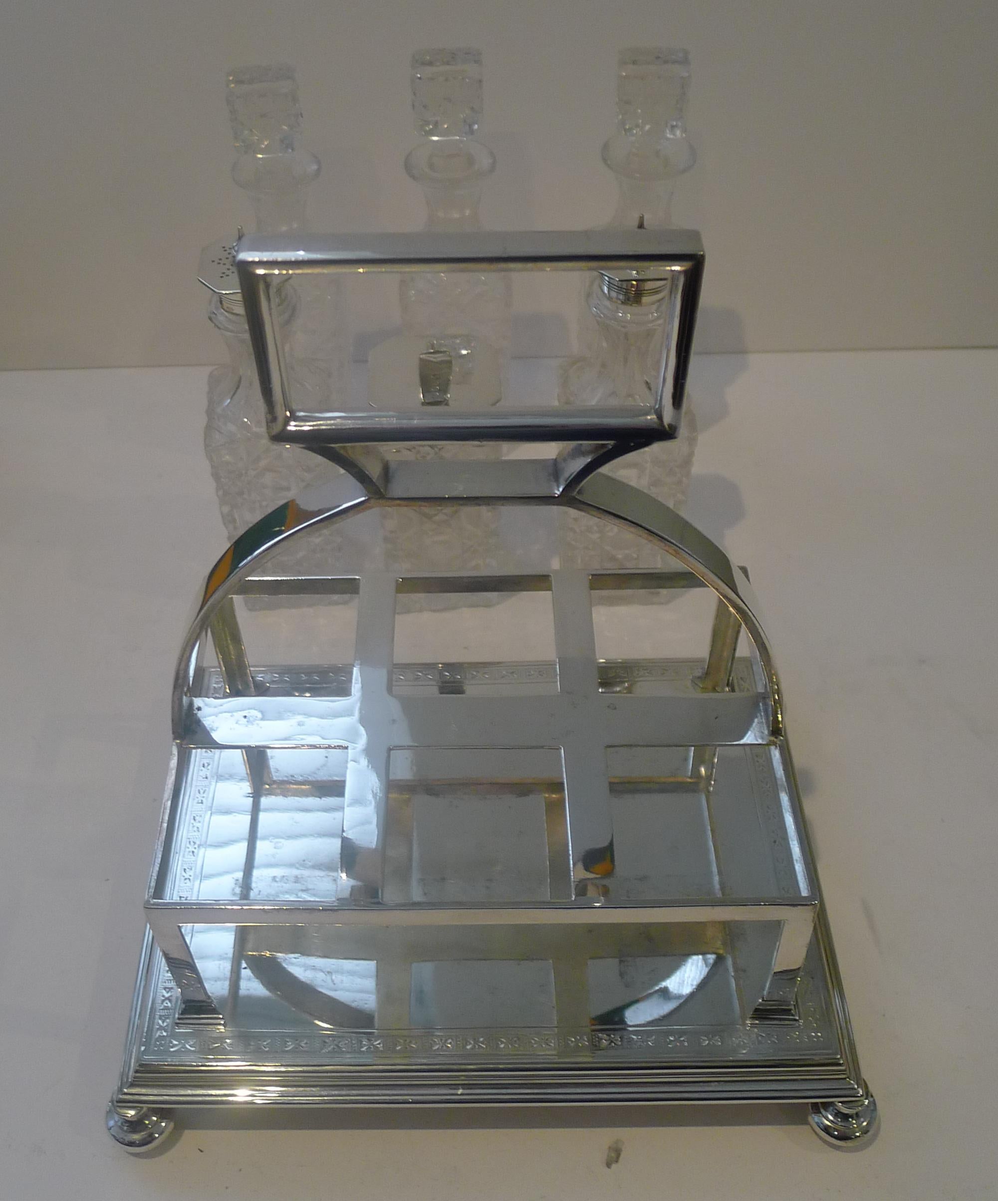 A handsome six bottle cruet, the stand made from silver plate, fully marked on the underside by the maker.

The base stands on four original bun feet and the base with a simple but elegant engraved decoration.

The set comprises of four condiment