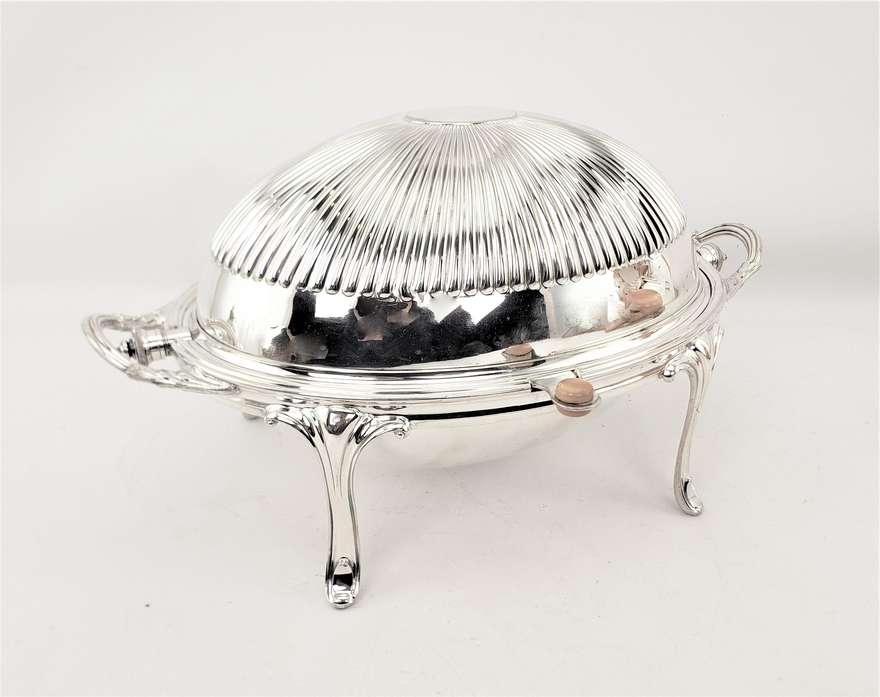 This very well designed and constructed silver plated breakfast warmer was made by James Dixon and Sons of England in approximately 1920 and done in a period Art Deco style. The server is done in a thick silver plate with a tilt domed top with