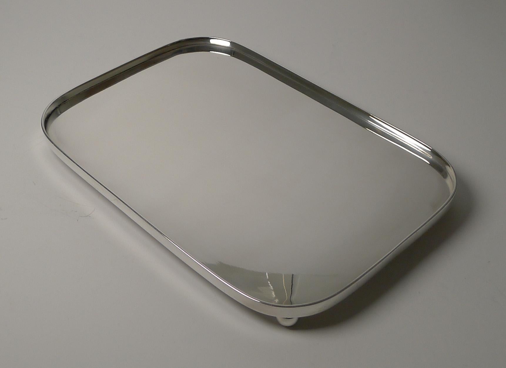 A fabulous antique drinks or cocktail tray standing on four original ball feet; rectangular in shape with rounded corners.

Dating to c.1880, late Victorian in era, the tray has a clean modernist look, simple and elegant. Just having returned from