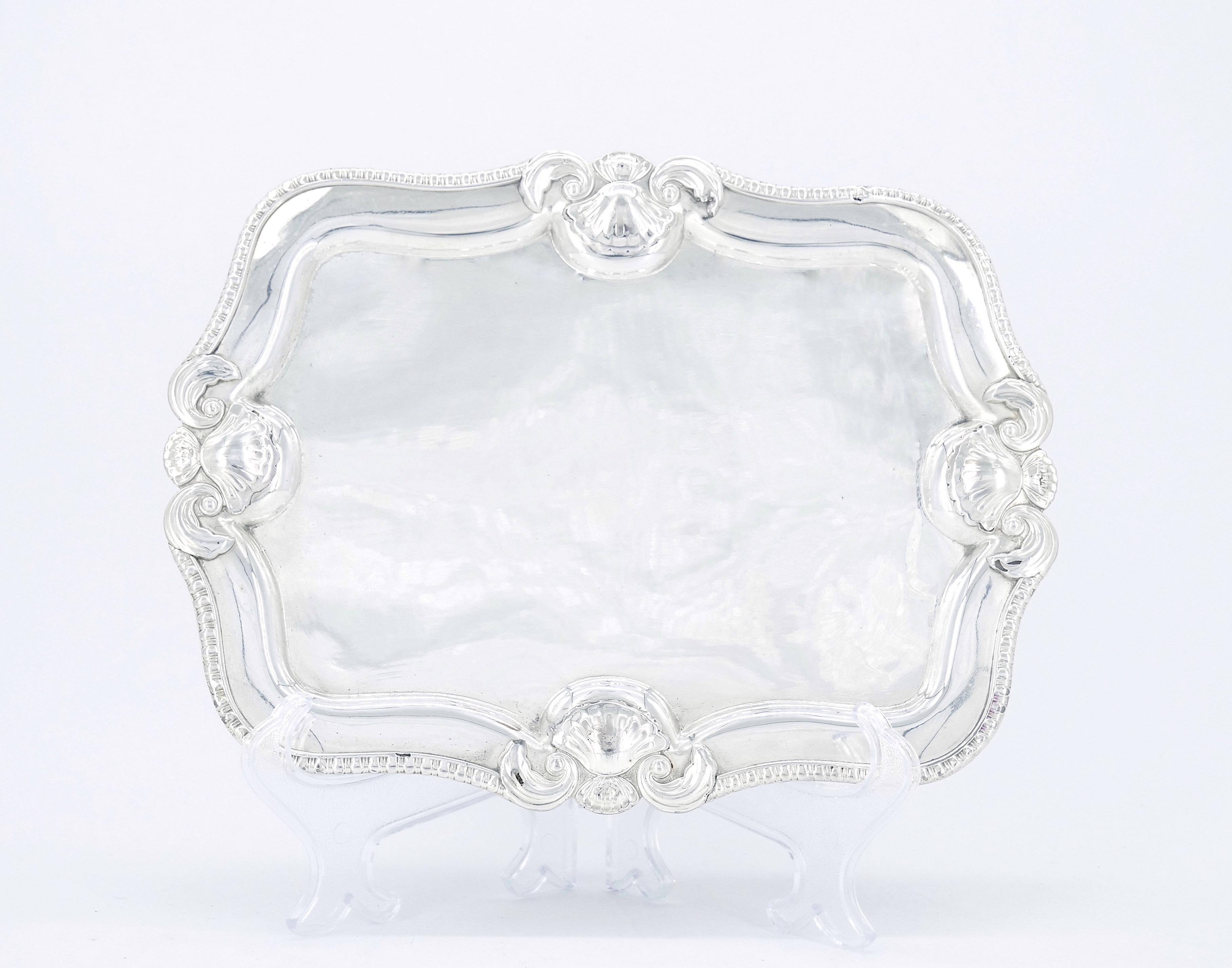 Discover the captivating beauty of our antique English silver-plated footed serving tray with a stunning border design. This remarkable piece seamlessly blends the allure of antiquity with the sophistication of intricate detailing and elevated feet.