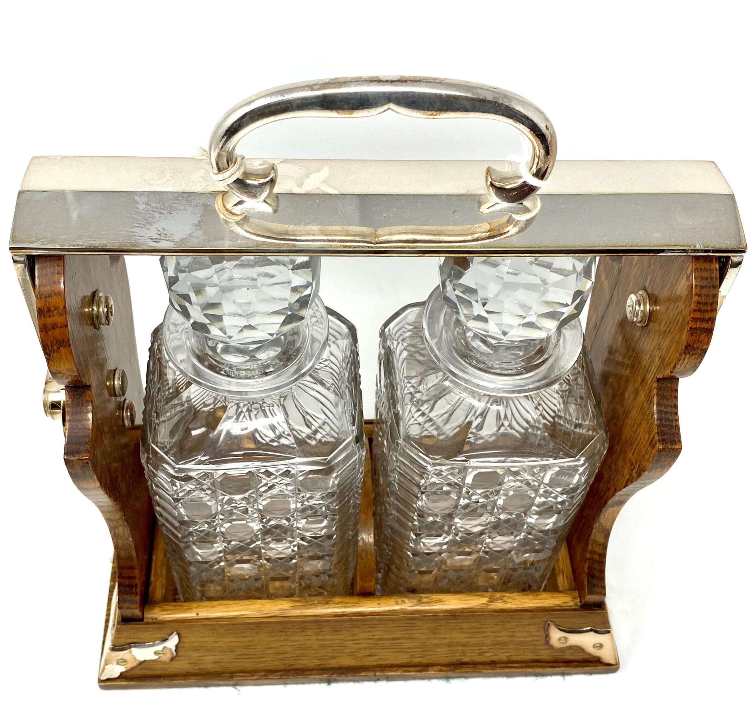 Antique English silver plated golden oak two bottle Tantalus, made by 