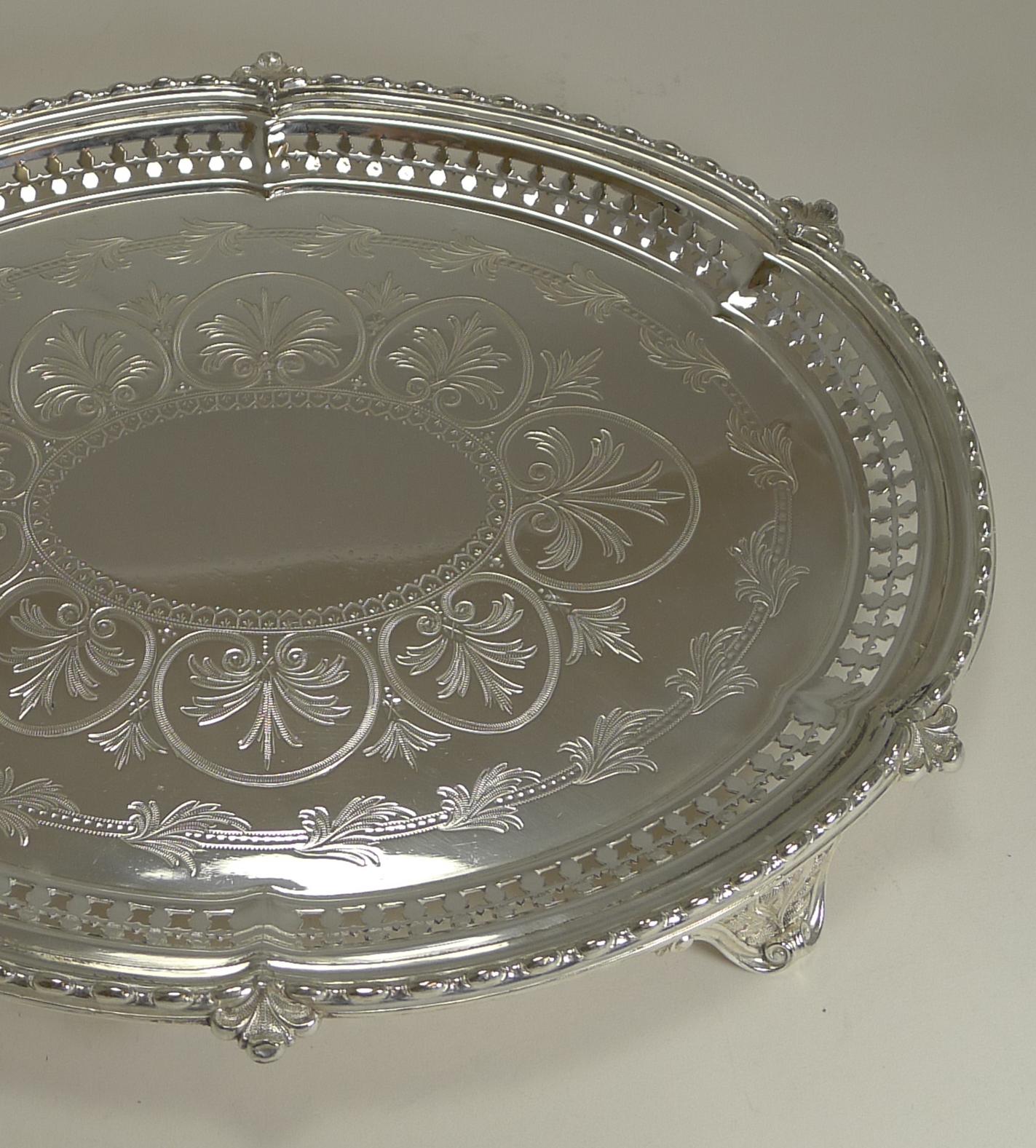 A fabulous oval shaped Victorian tray or salver standing on four very elegantly decorated legs. It is unusual to find a salver in this oval shape.

The side of the tray is pierced or reticulated and the base beautifully engraved and a most